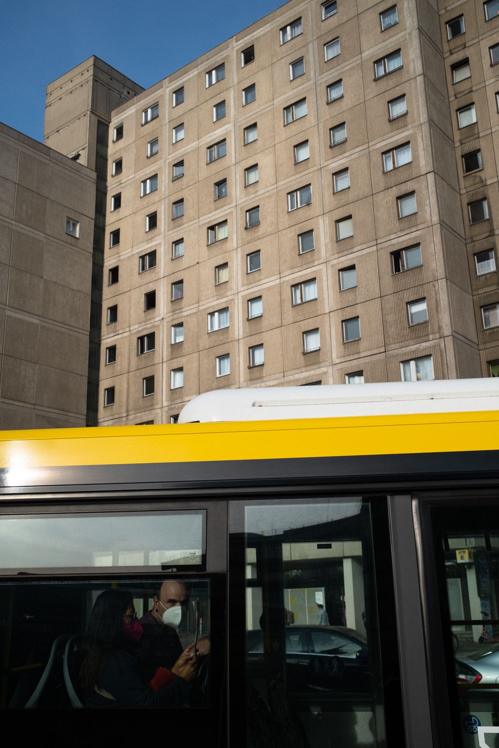 Bus am Alexanderplatz in Berlin Mitte. Ein Mann schaut aus dem Fenster. Er trägt wegen der Corona Pandemie eine Maske.