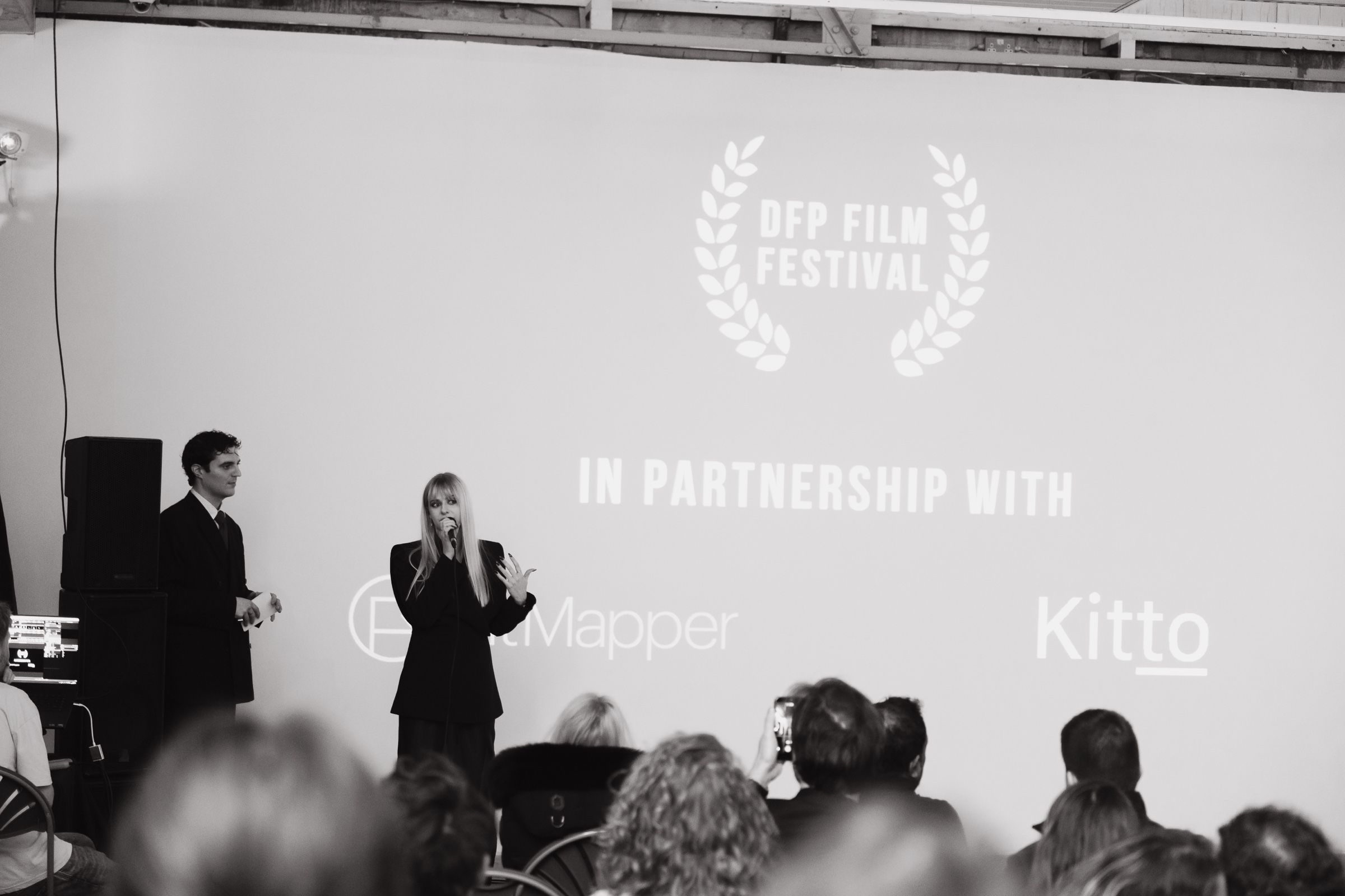 Hosts open the DFP Film Festival beneath the projected titles, presented with KitMapper and Kitto.