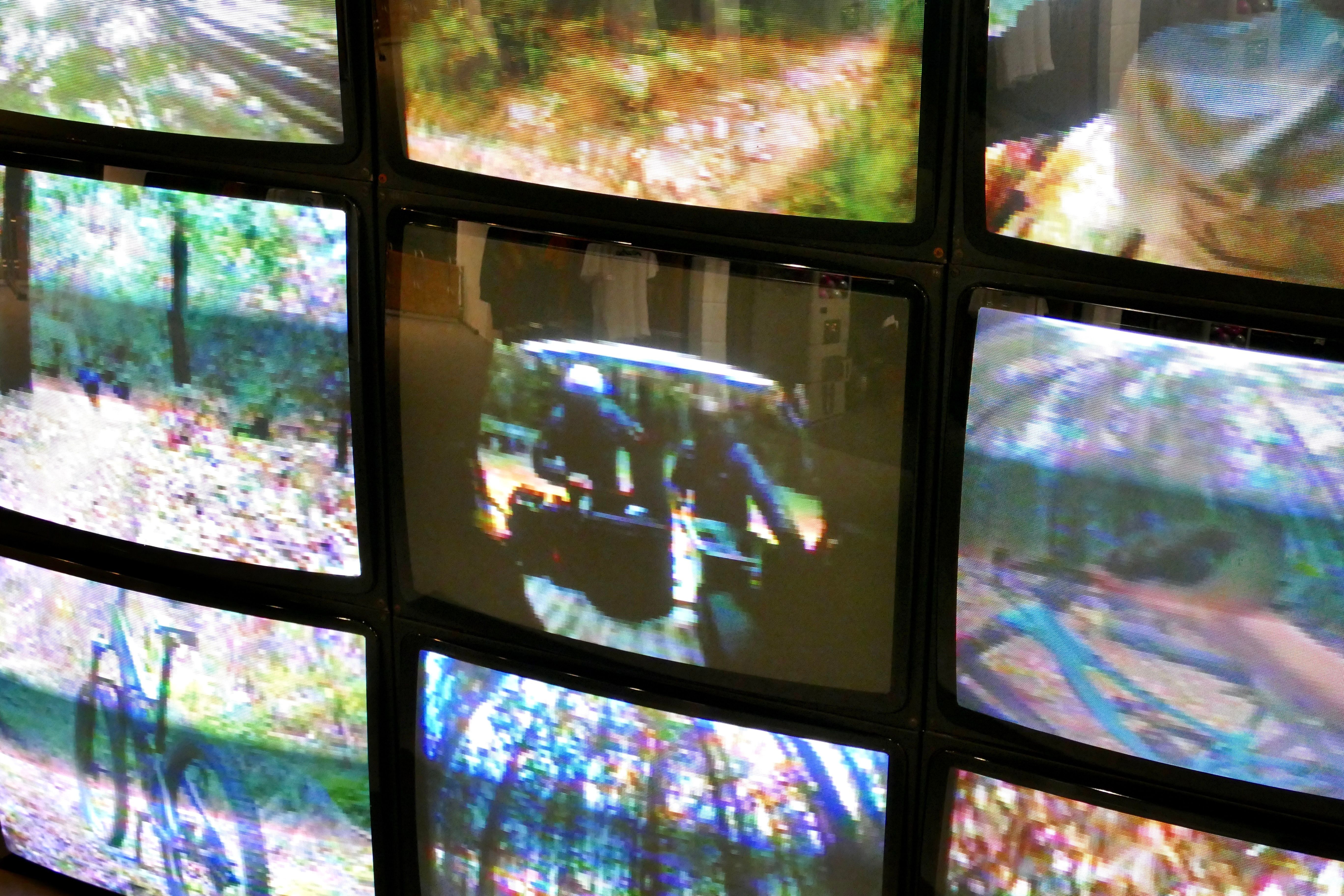 Wall of CRT monitors showing mountain-bike footage, Rapha, Soho