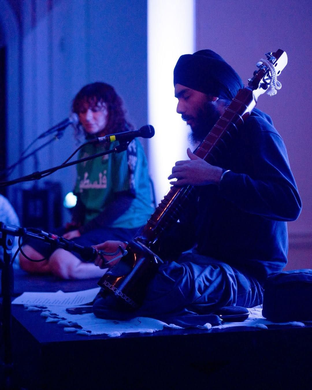 Two musicians performing under blue light, Assembly 2026, Somerset House Studios