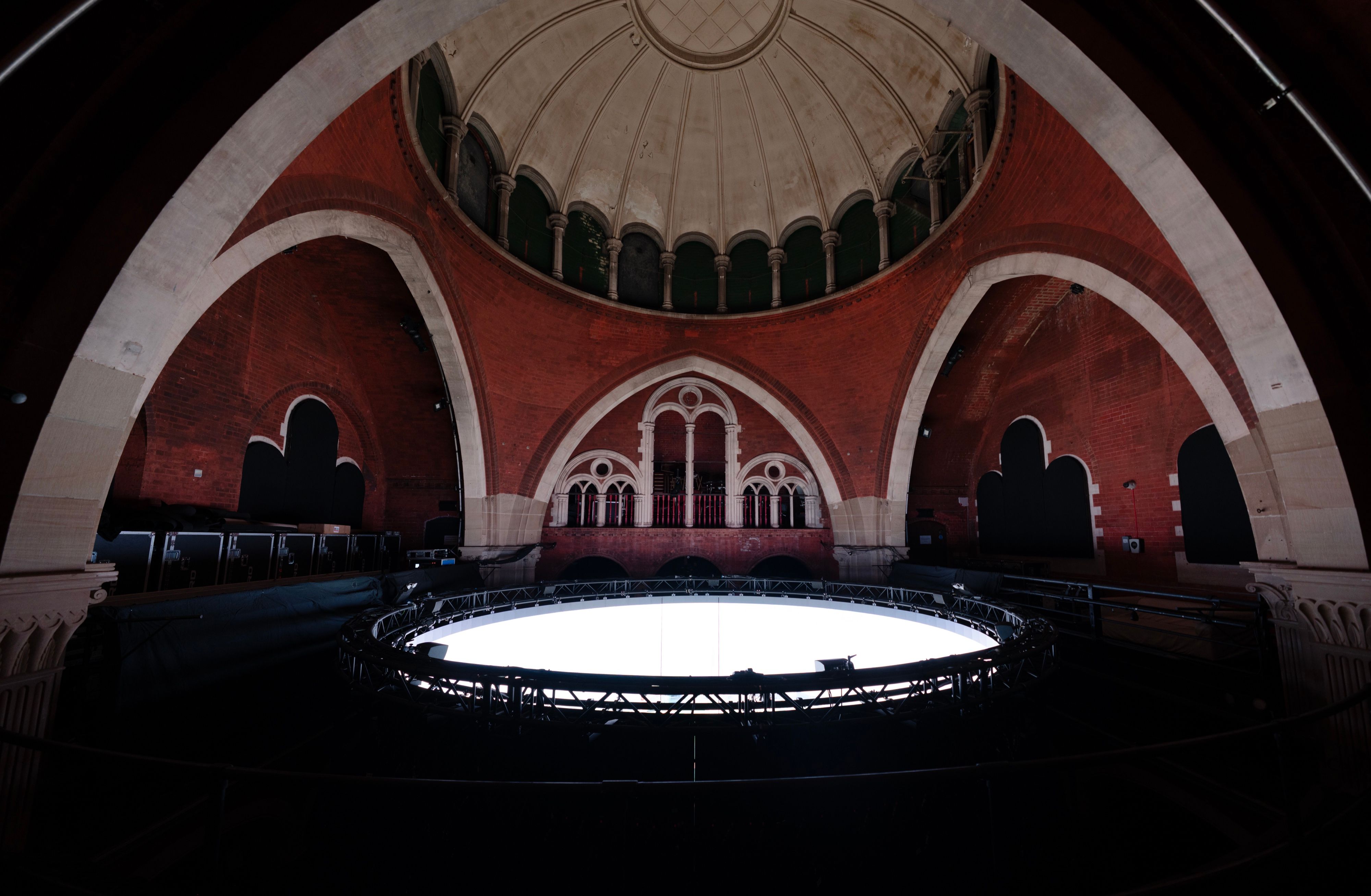 The LED cylinder of On The Other Earth on its ring of truss beneath the dome of Stone Nest, Wayne McGregor, London