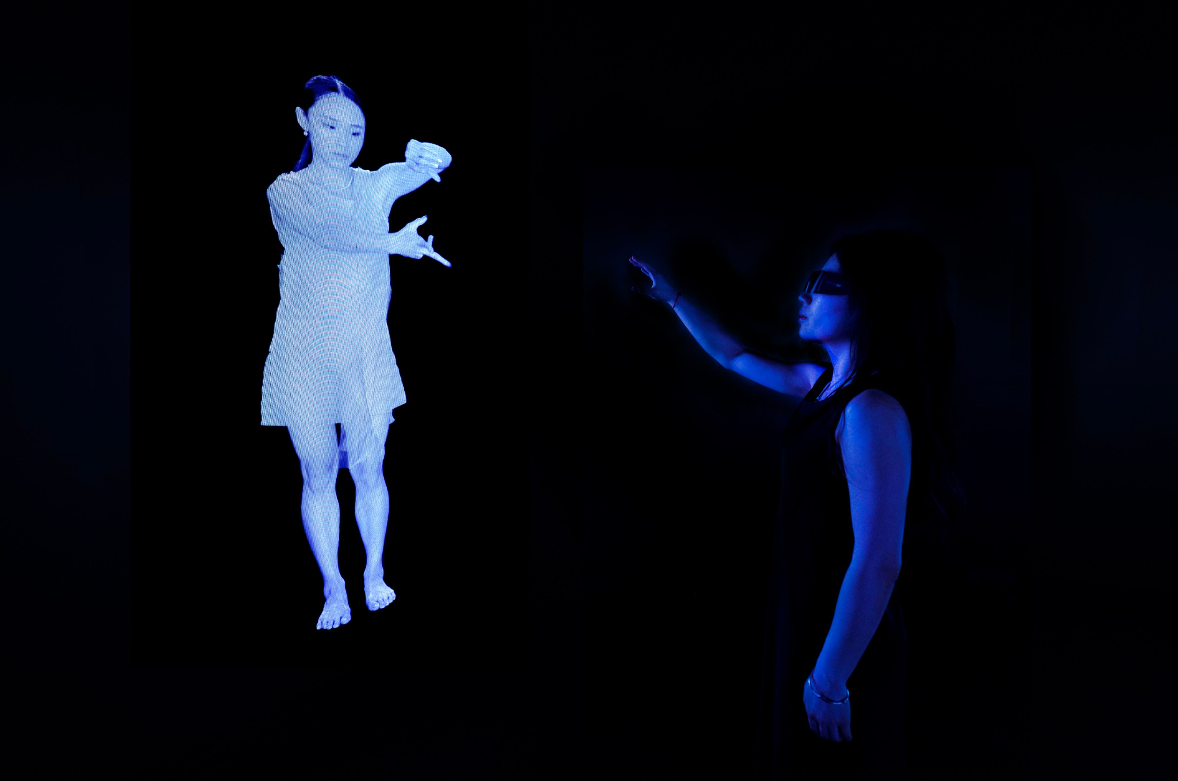 A visitor reaching towards a life-size stereoscopic dancer, Wayne McGregor, On The Other Earth, Stone Nest