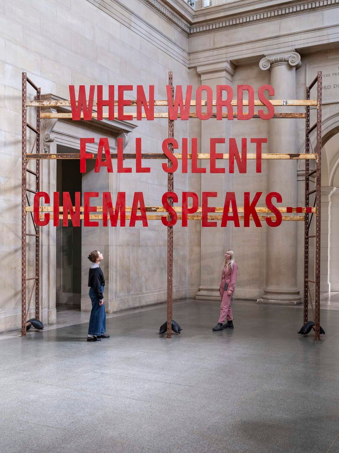 Red title lettering on scaffolding in the Duveen Galleries, Zineb Sedira, When Words Fall Silent, Cinema Speaks…, Tate Britain