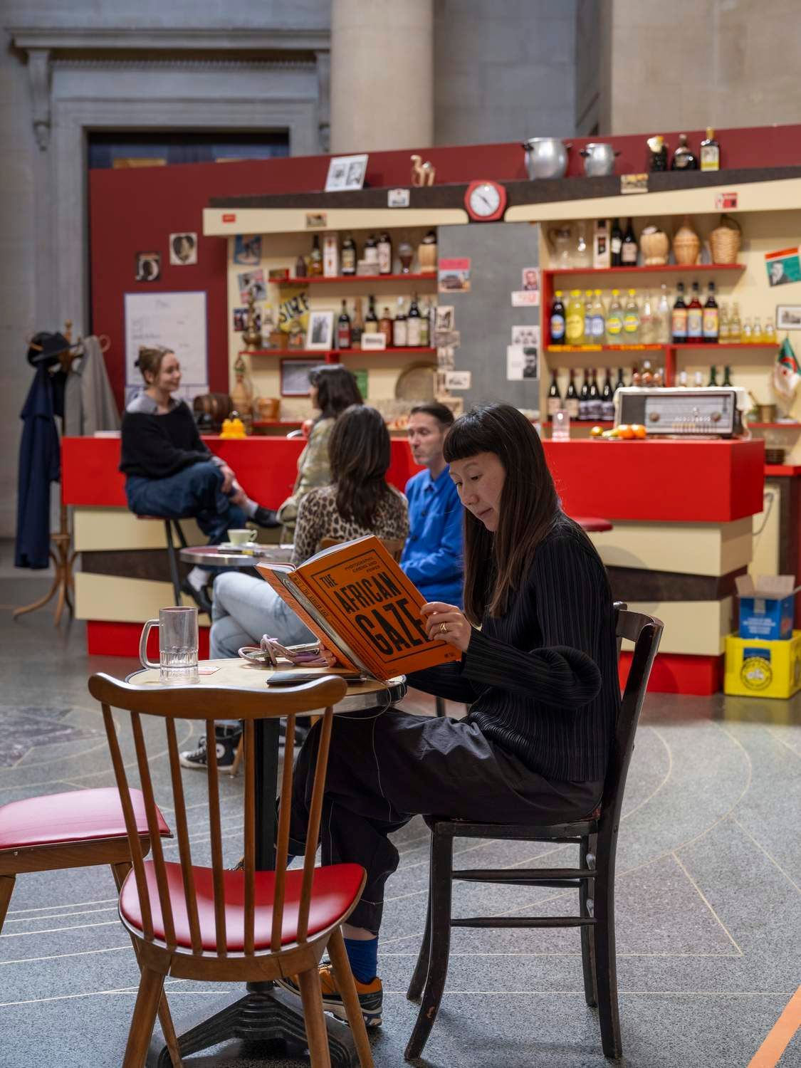 Visitors reading in the café set, Zineb Sedira, When Words Fall Silent, Cinema Speaks…, Tate Britain