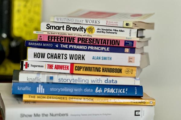 A pile of books about writing, using charts and stories to communicate.  