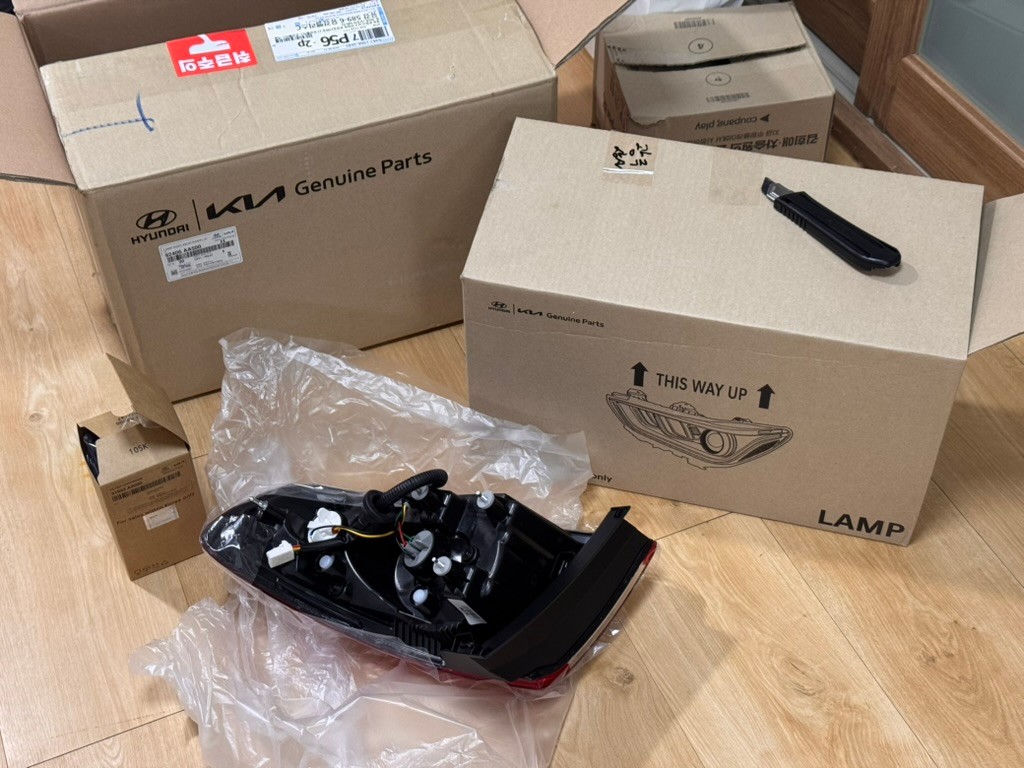 Parts boxes containing a replacement tail light and fuel filter cartridge