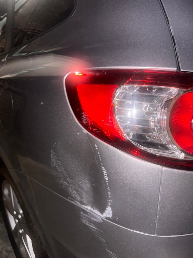 Scratched bodywork and a cracked tail light
