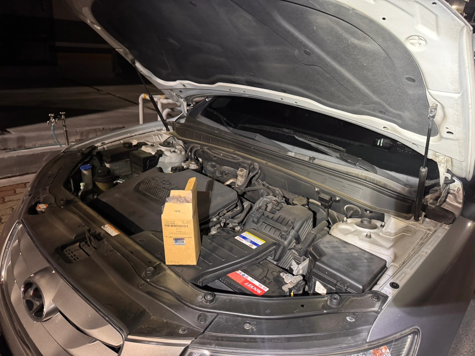Engine bay with the hood open, ready for fuel filter replacement