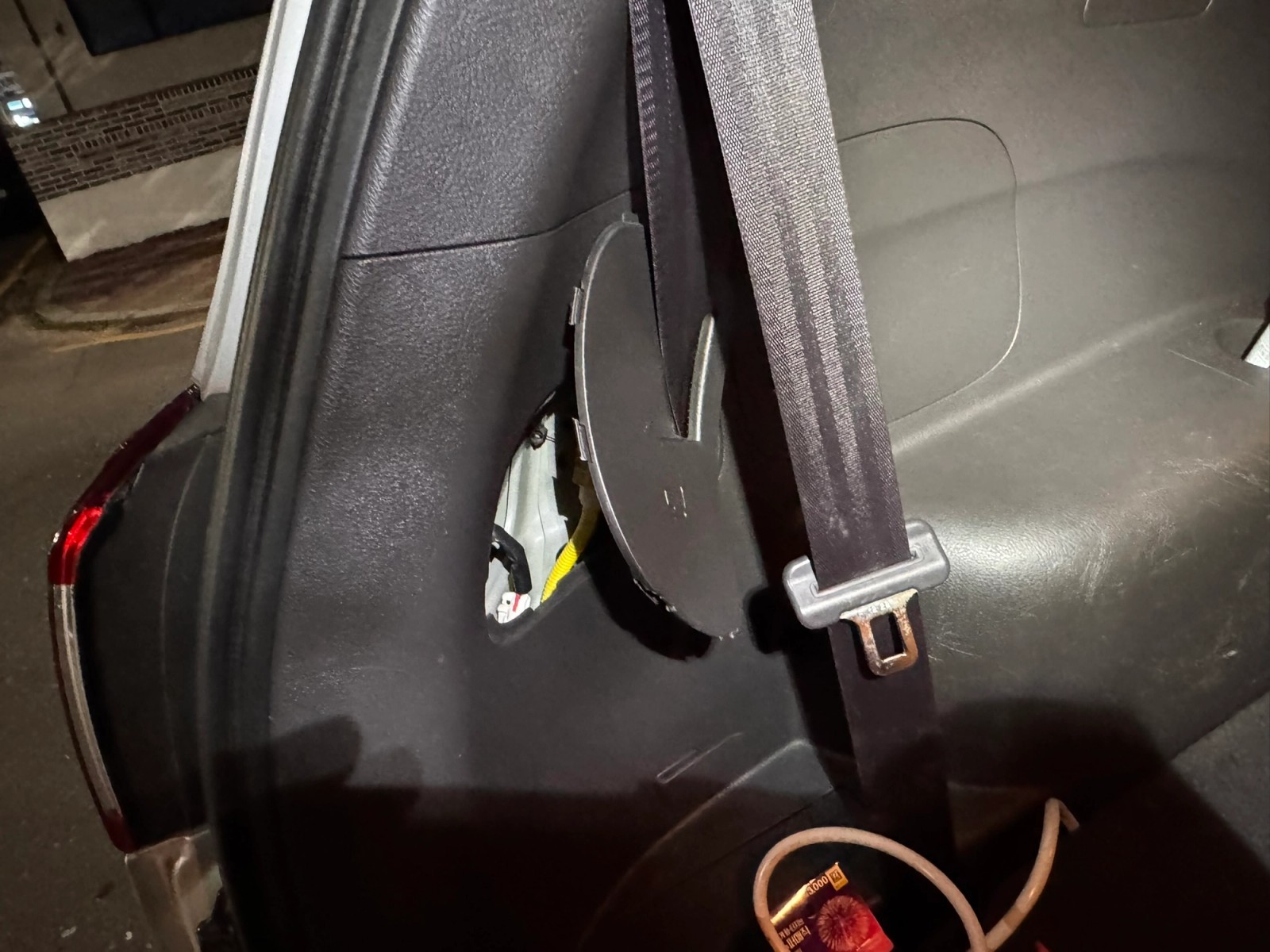 Tail light access panel and seat belt inside the trunk