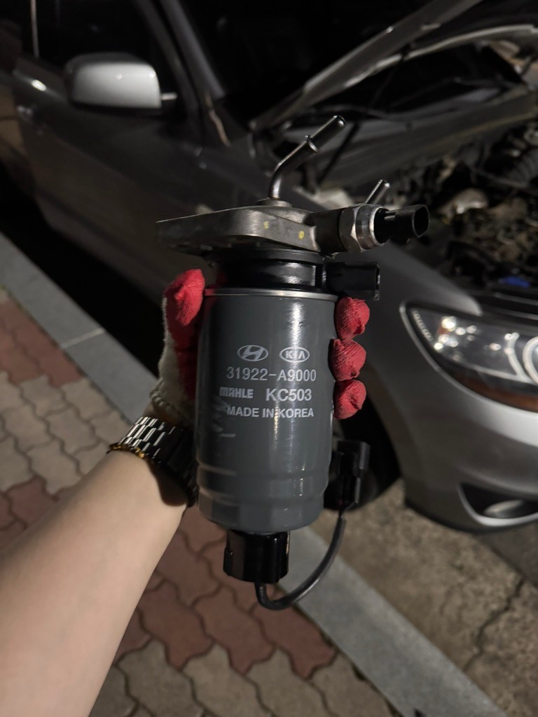 Fuel filter assembly reassembled with the replacement cartridge