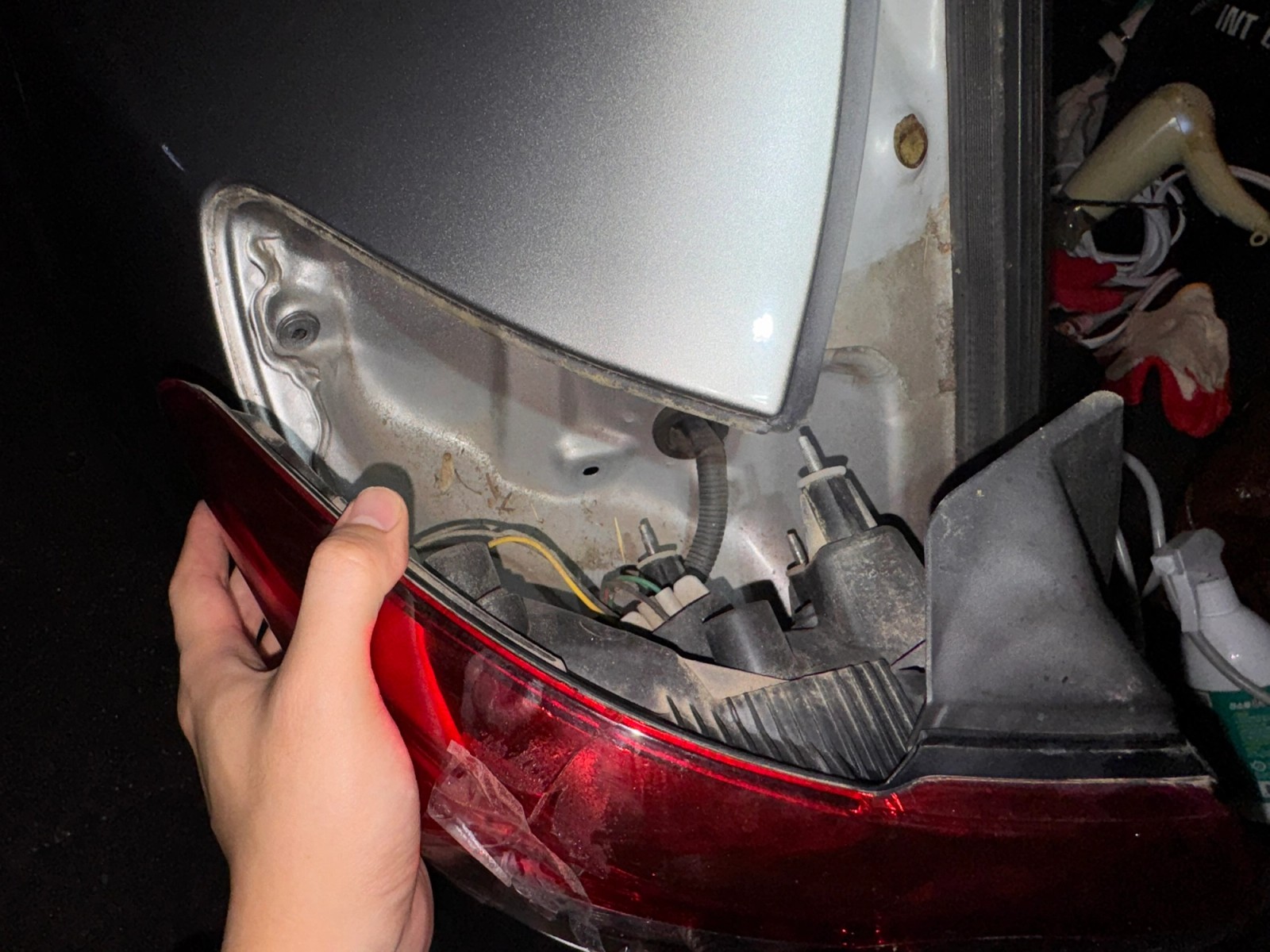 Removing the tail light from the vehicle body