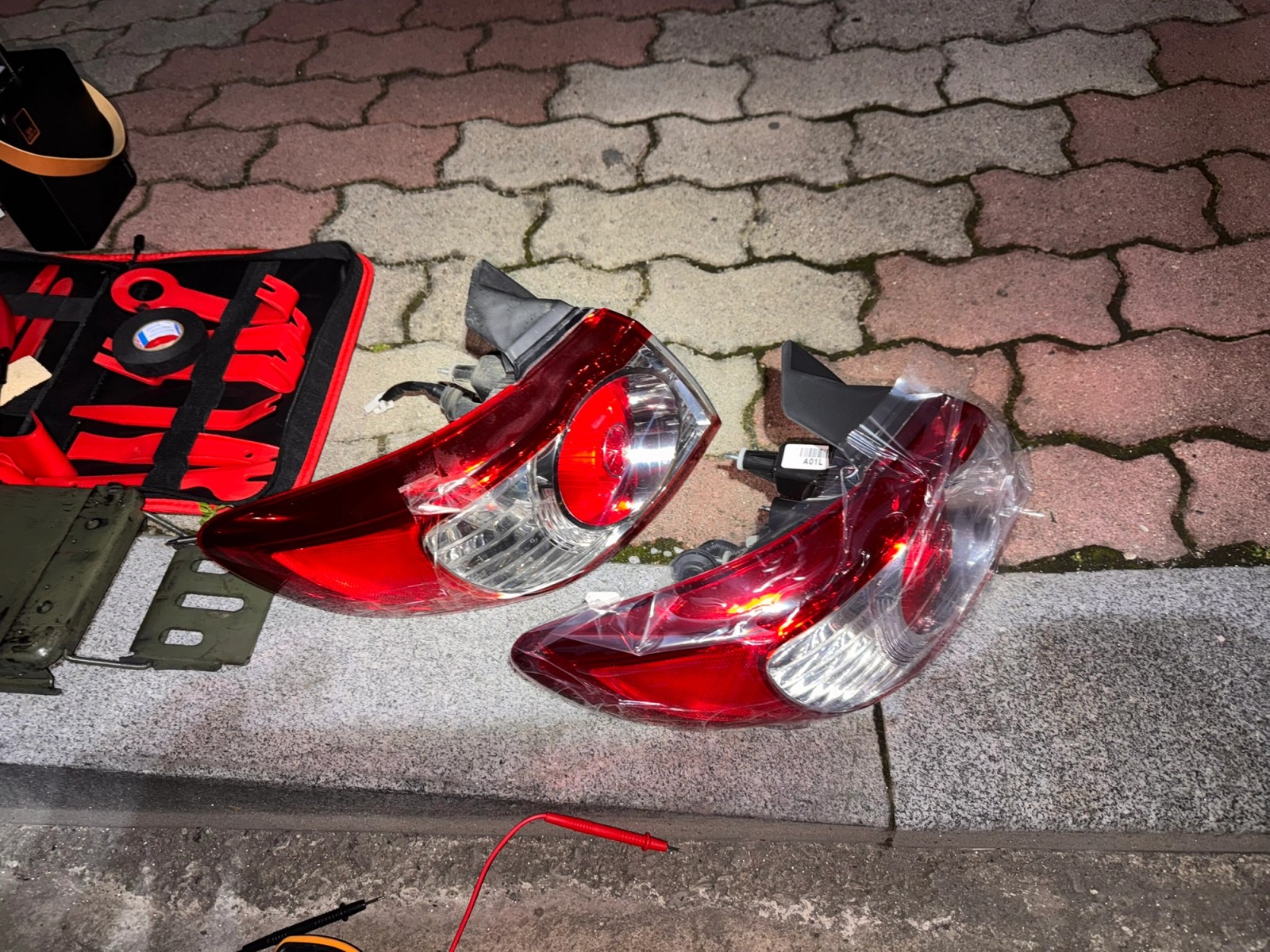 New and old tail lights placed on the ground for comparison