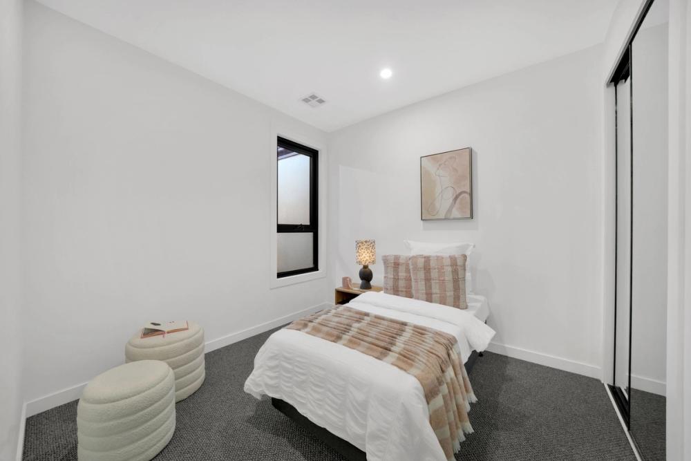 Second bedroom with built-in robe and black-framed window, Tarneit Cathedral Residence, Tarneit