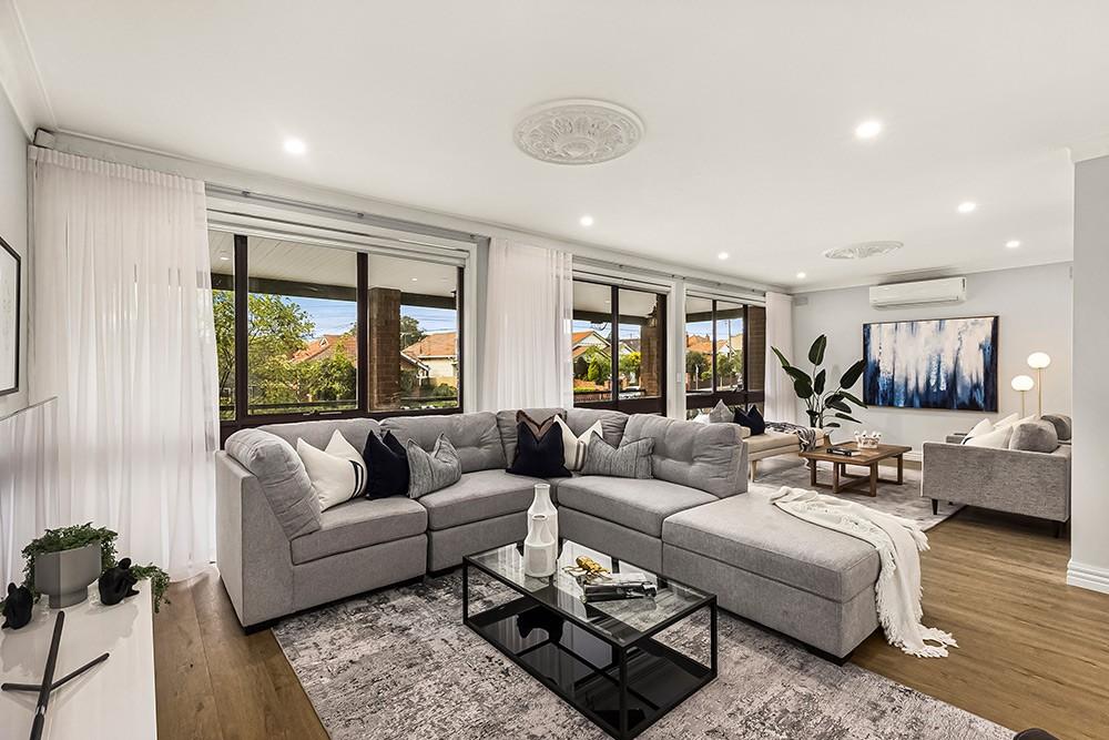Living room with a grey corner sofa, ceiling rose and sheer curtains, Brunswick Transformation, Brunswick