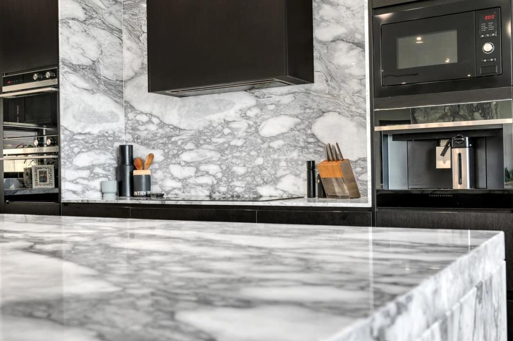 Kitchen with marble island and splashback and black overhead cabinetry, Tiffany Walk Residence, Sanctuary Lakes
