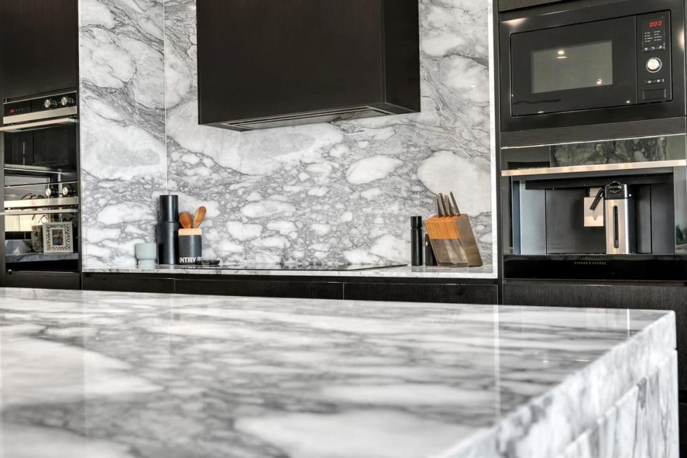 Kitchen with marble island and splashback and black overhead cabinetry, Tiffany Walk Residence, Sanctuary Lakes