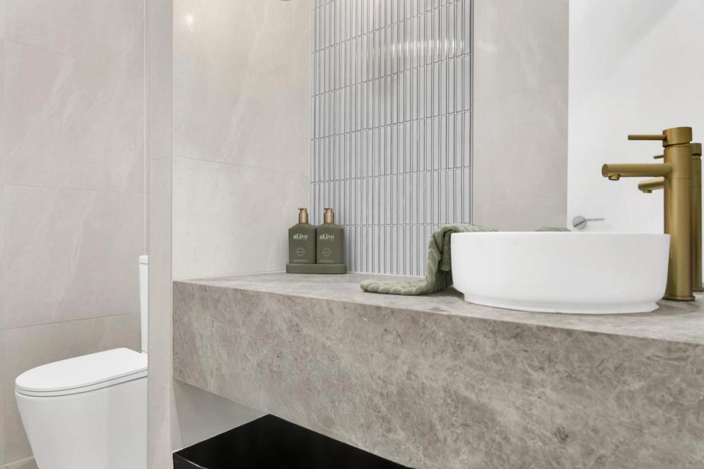 Powder room with a stone floating vanity, vessel basin and gold tap, Tiffany Walk Residence, Sanctuary Lakes