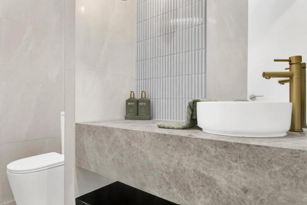 Powder room with a stone floating vanity, vessel basin and gold tap, Tiffany Walk Residence, Sanctuary Lakes