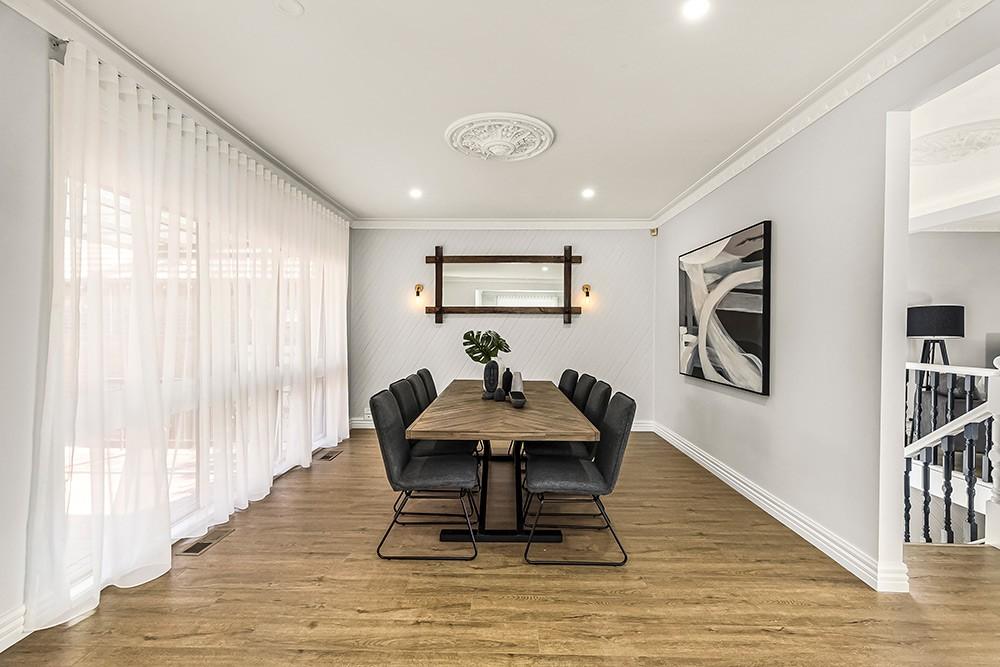 Dining area with timber table, black chairs and a wall mirror, Brunswick Transformation, Brunswick