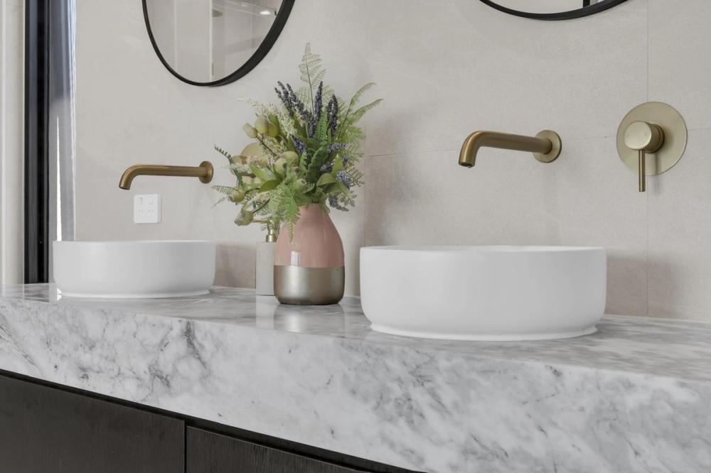 Ensuite with twin vessel basins on a marble benchtop and gold tapware, Tiffany Walk Residence, Melbourne