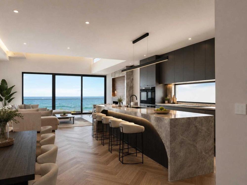 Open-plan living and kitchen with a stone waterfall island and bay views, Seaholme Residences, Melbourne