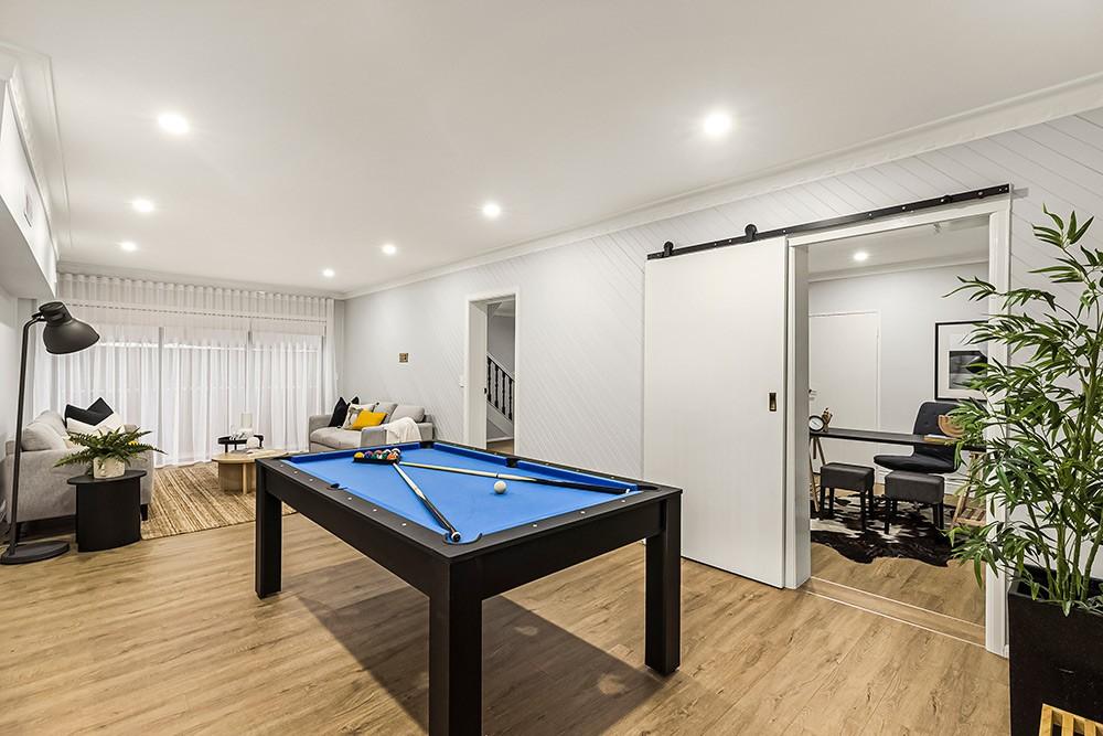 Rumpus room with a pool table and barn door beside a lounge and study nook, Brunswick Transformation, Melbourne