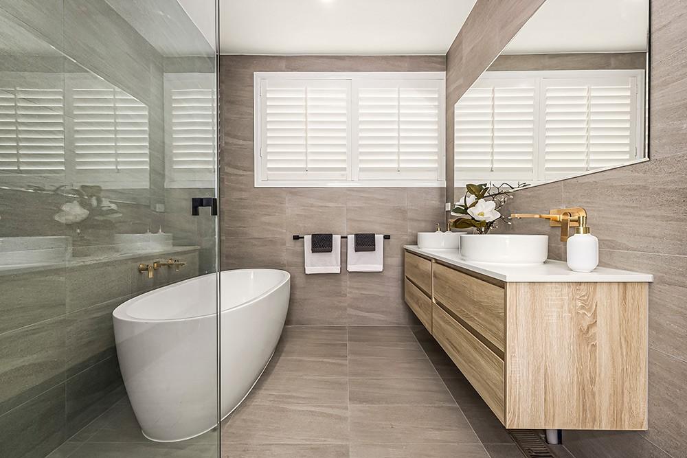 Bathroom with freestanding oval tub, twin-basin timber vanity and plantation shutters, Brunswick Transformation, Melbourne