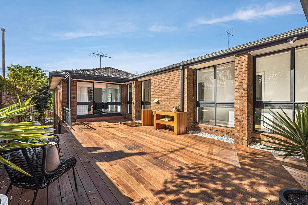 Rear timber deck beside the brick extension with large windows, Brunswick Transformation, Melbourne