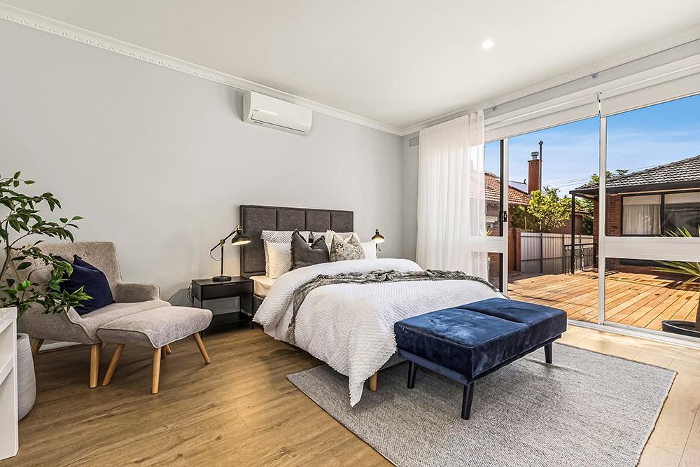 Bedroom opening to a timber deck through sliding doors, Brunswick Transformation, Brunswick