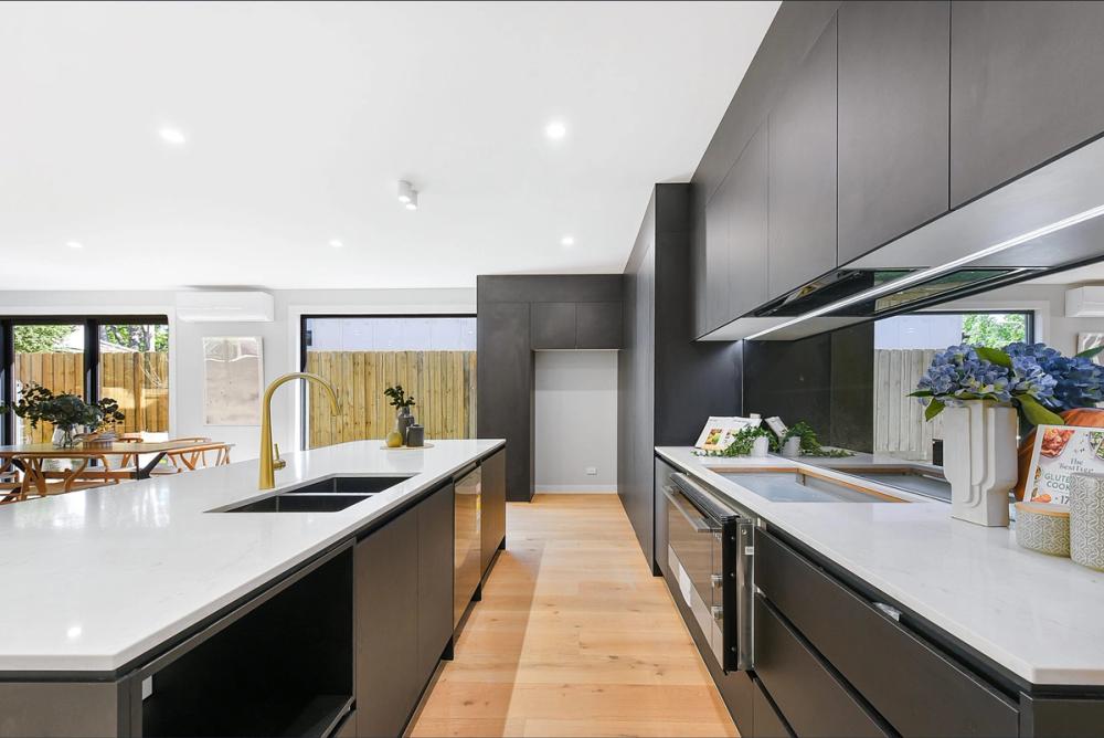 Kitchen with white island bench and black overhead cabinetry, Bentleigh East Development, Melbourne