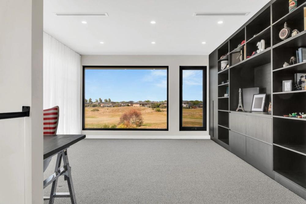 Home office with black built-in joinery and golf-course views, Tiffany Walk Residence, Sanctuary Lakes