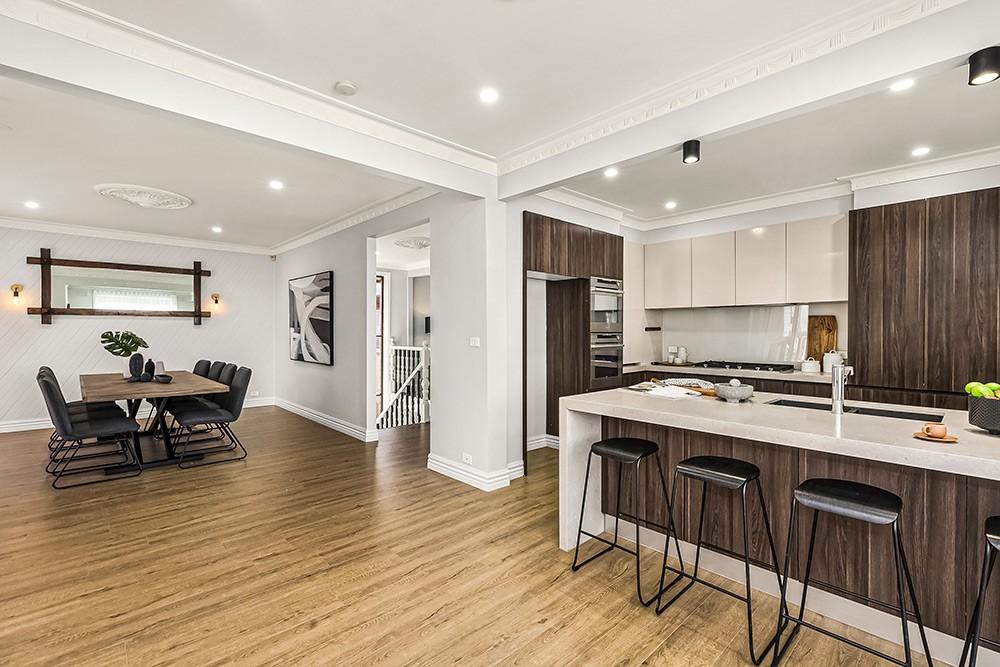Open-plan dining and kitchen with the staircase beyond, Brunswick Transformation, Melbourne