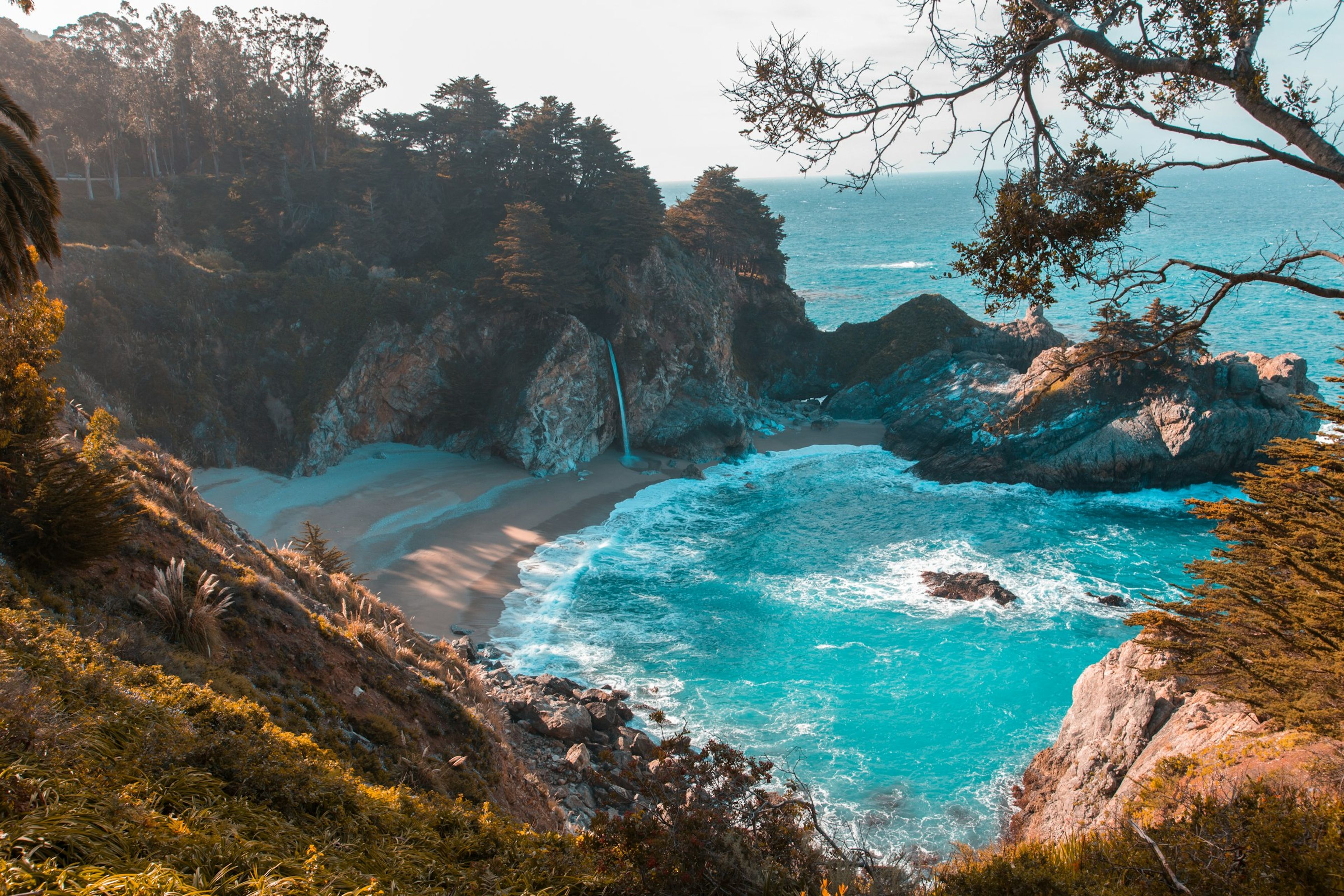 Turquoise cove framed by cliffs and trees