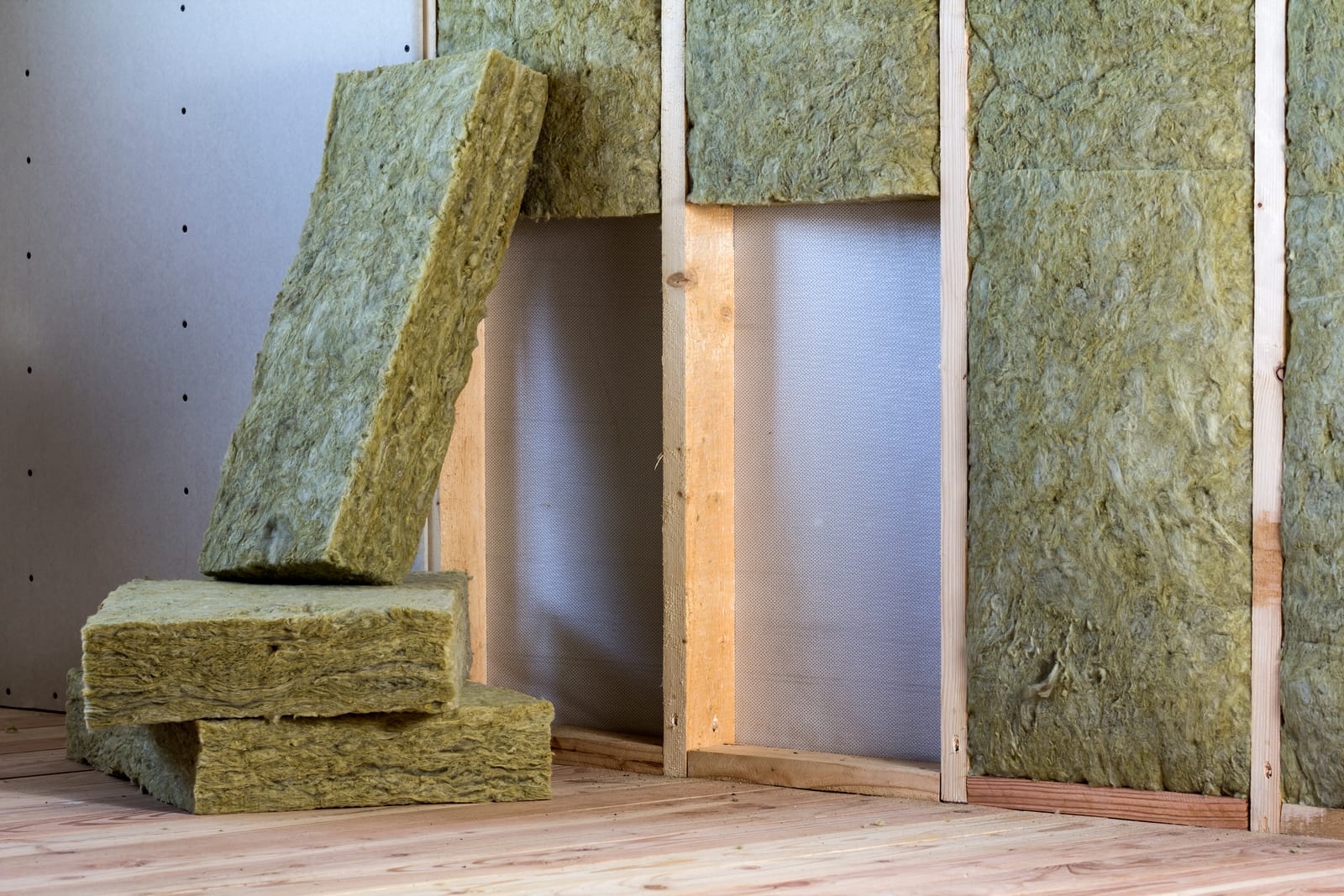 Wooden wall framing with drywall panels in a building under construction