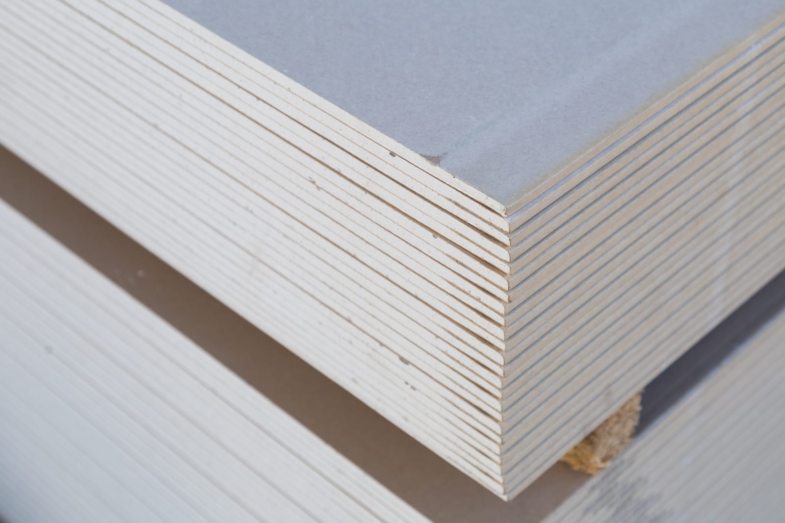 Stack of drywall sheets stored in a wholesale warehouse