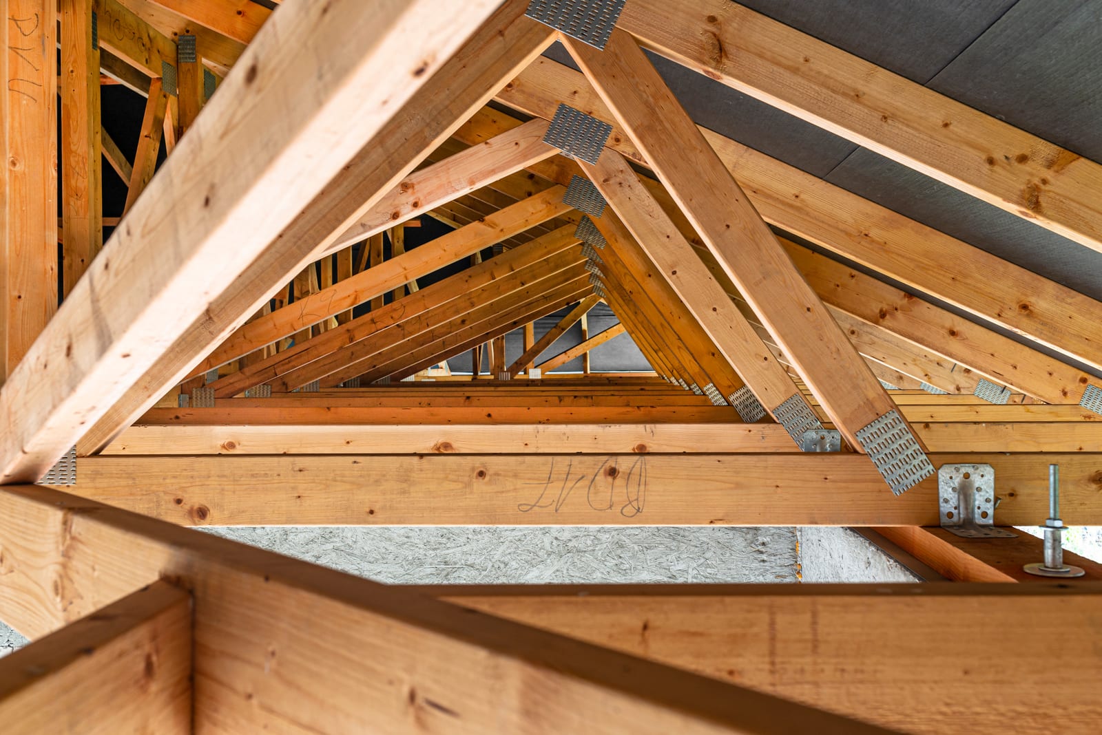 Roof truss framing with metal connector plates during residential construction