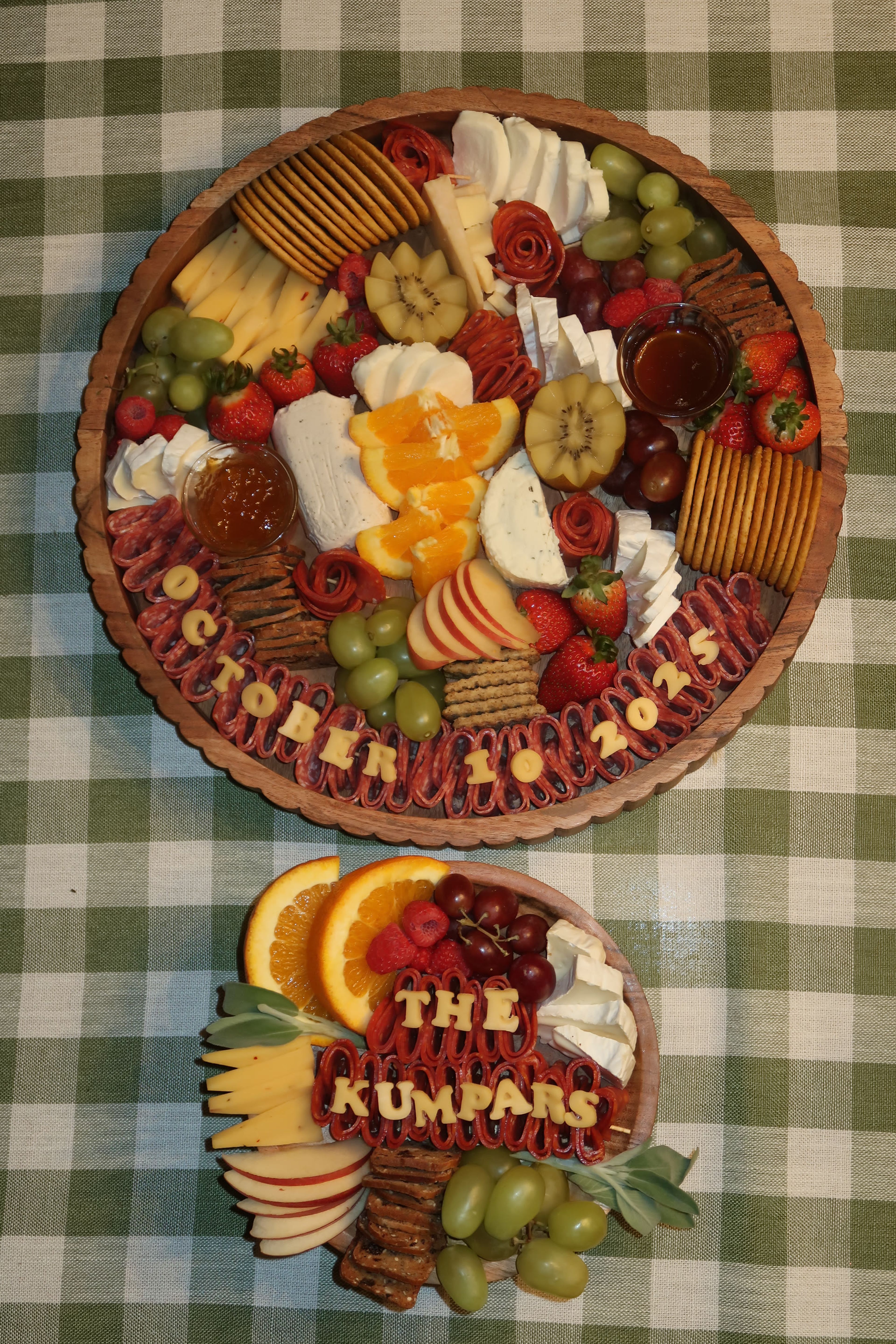 A round board lettered 'The Kumpars, October 10' on green gingham