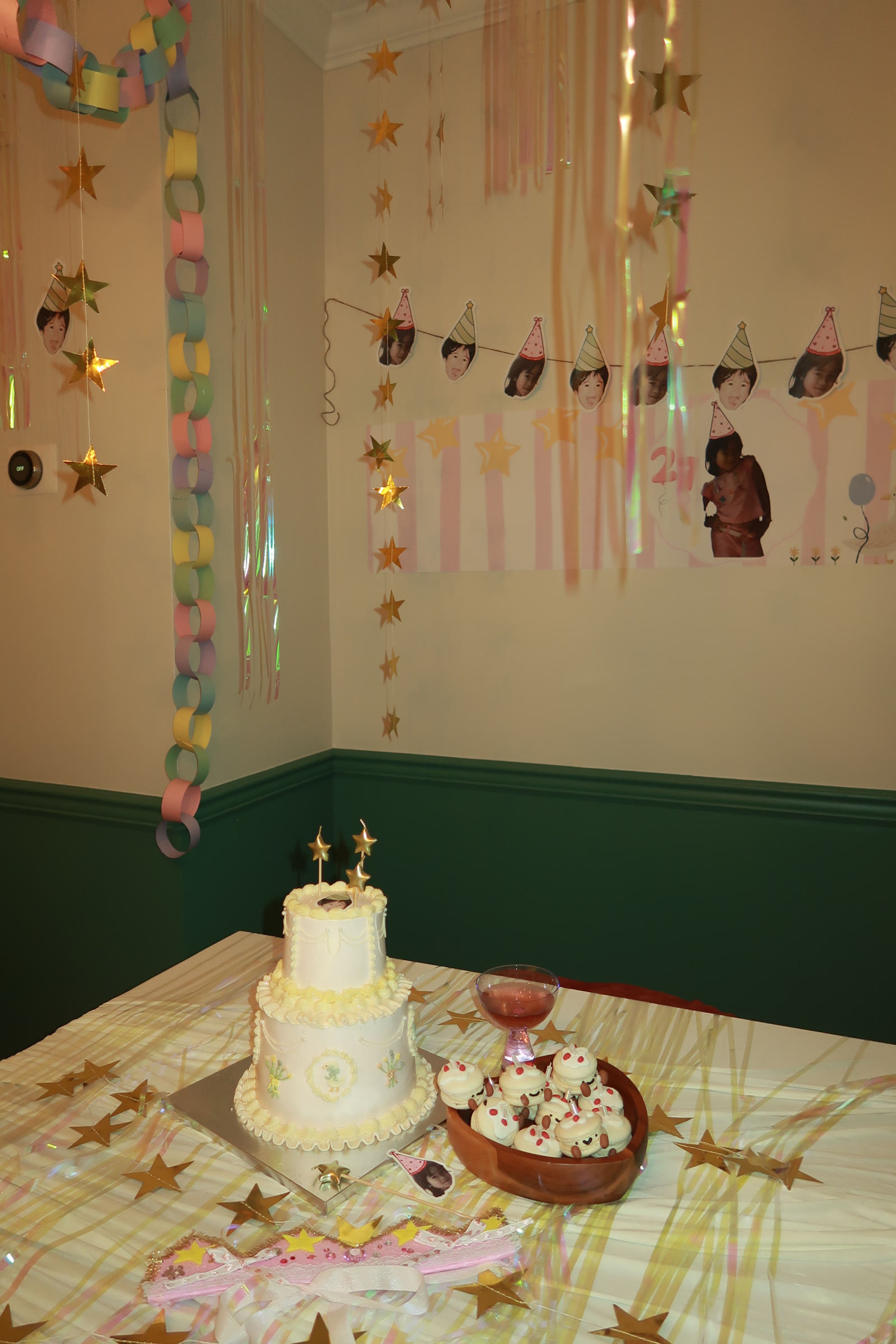 Streamers and a photo garland strung above the cake table