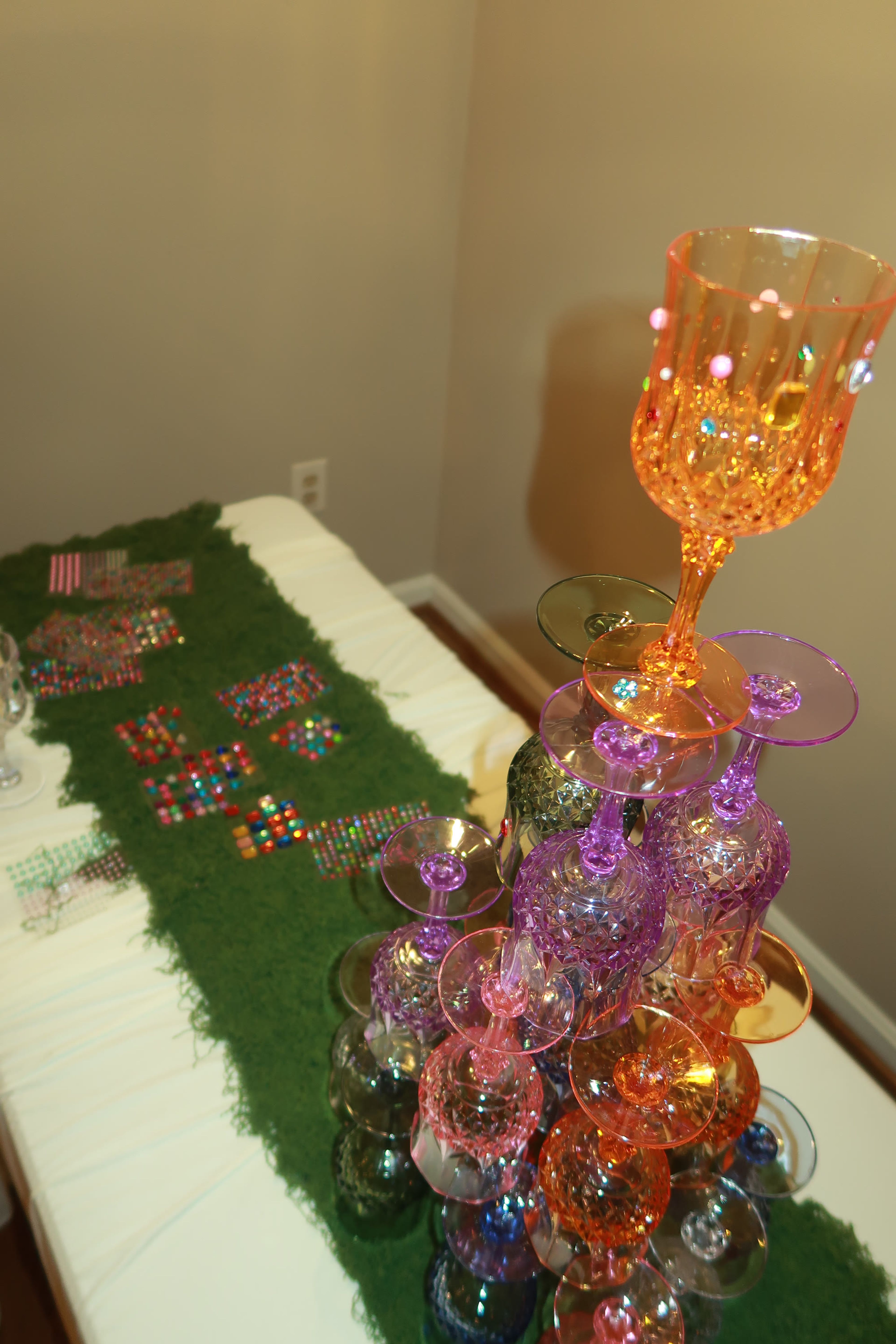 A moss table runner set with coloured glassware