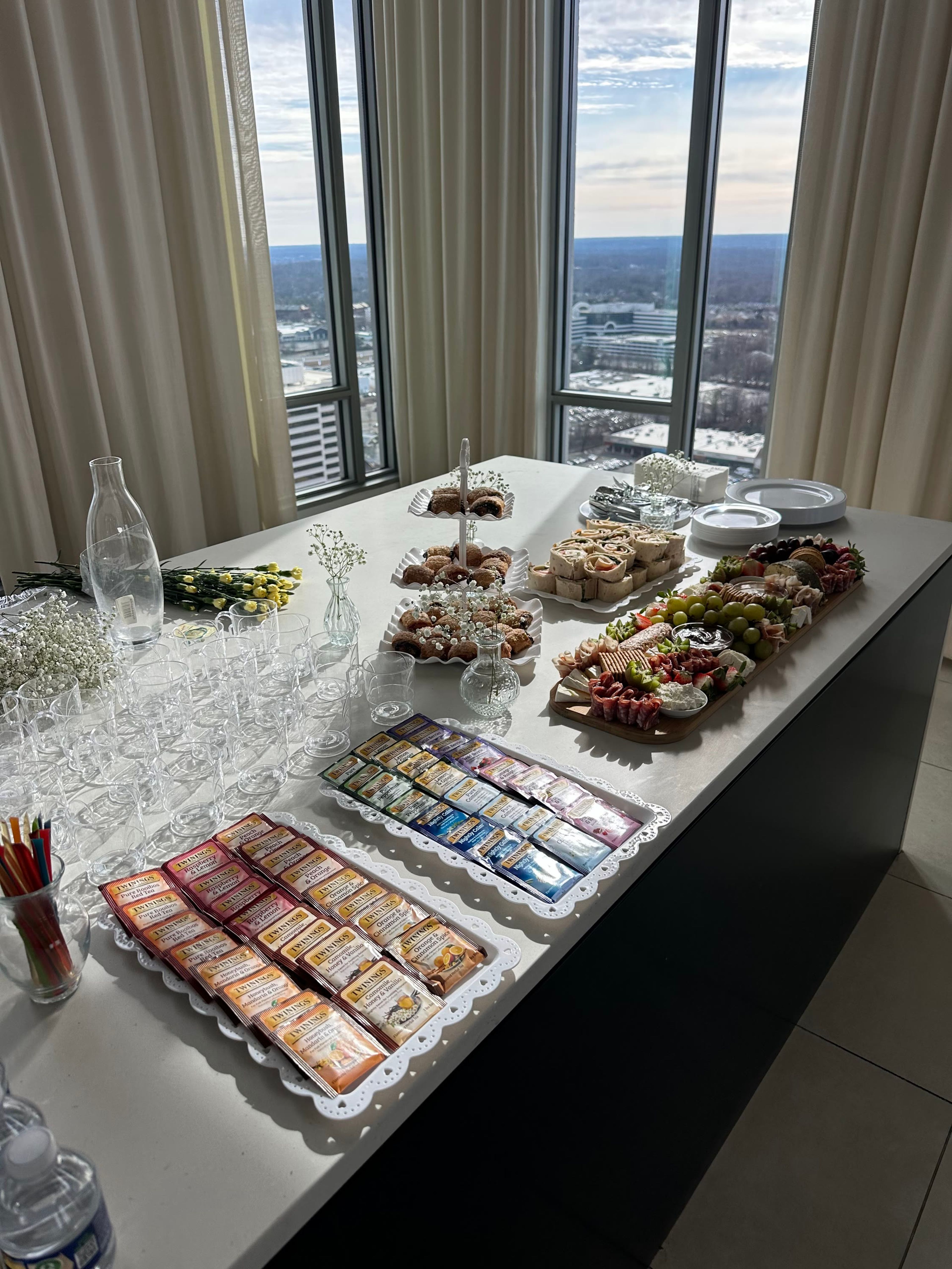 A table of desserts and boards beside a window