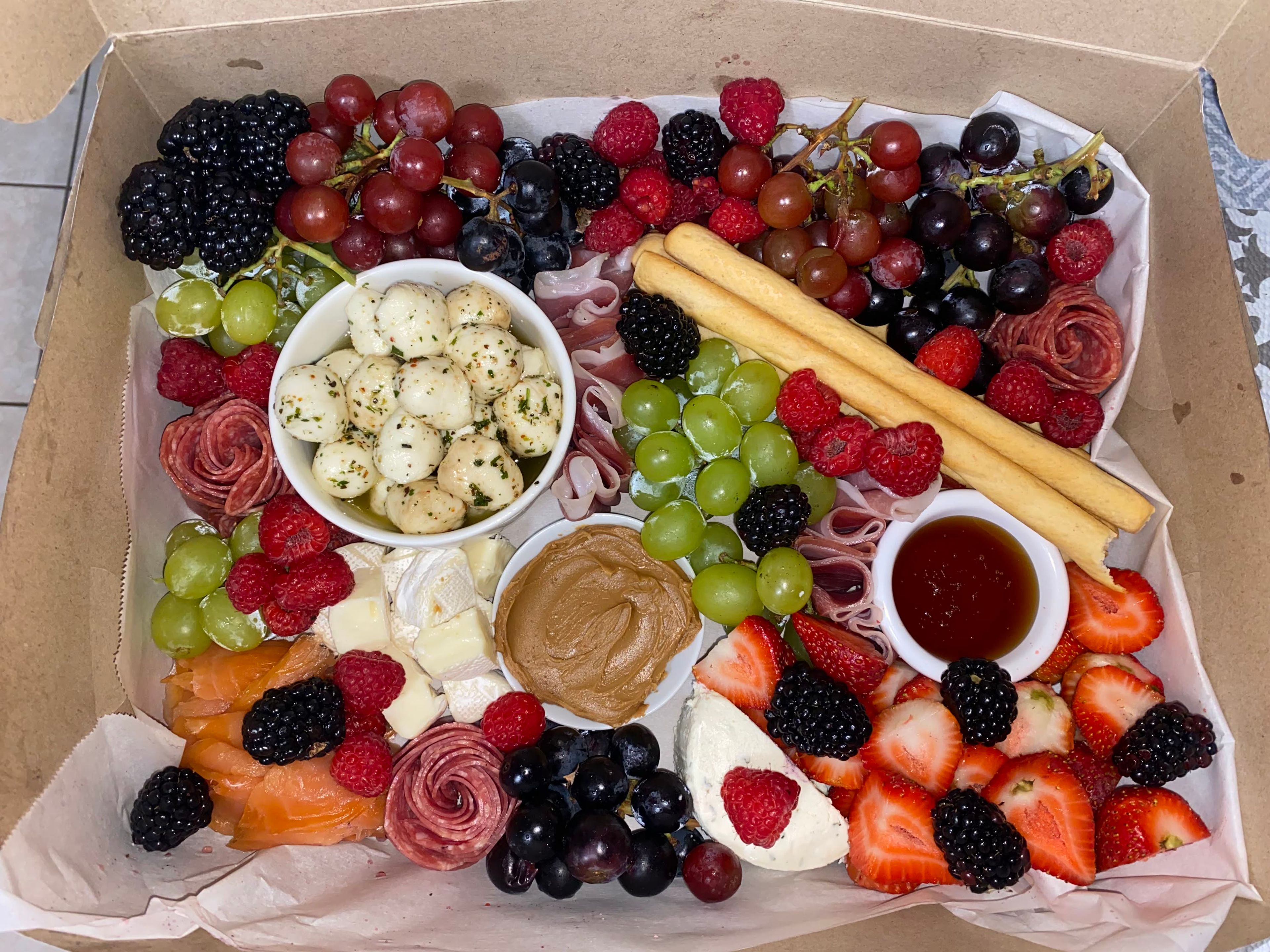 An overhead blue and white table setting with a grazing board