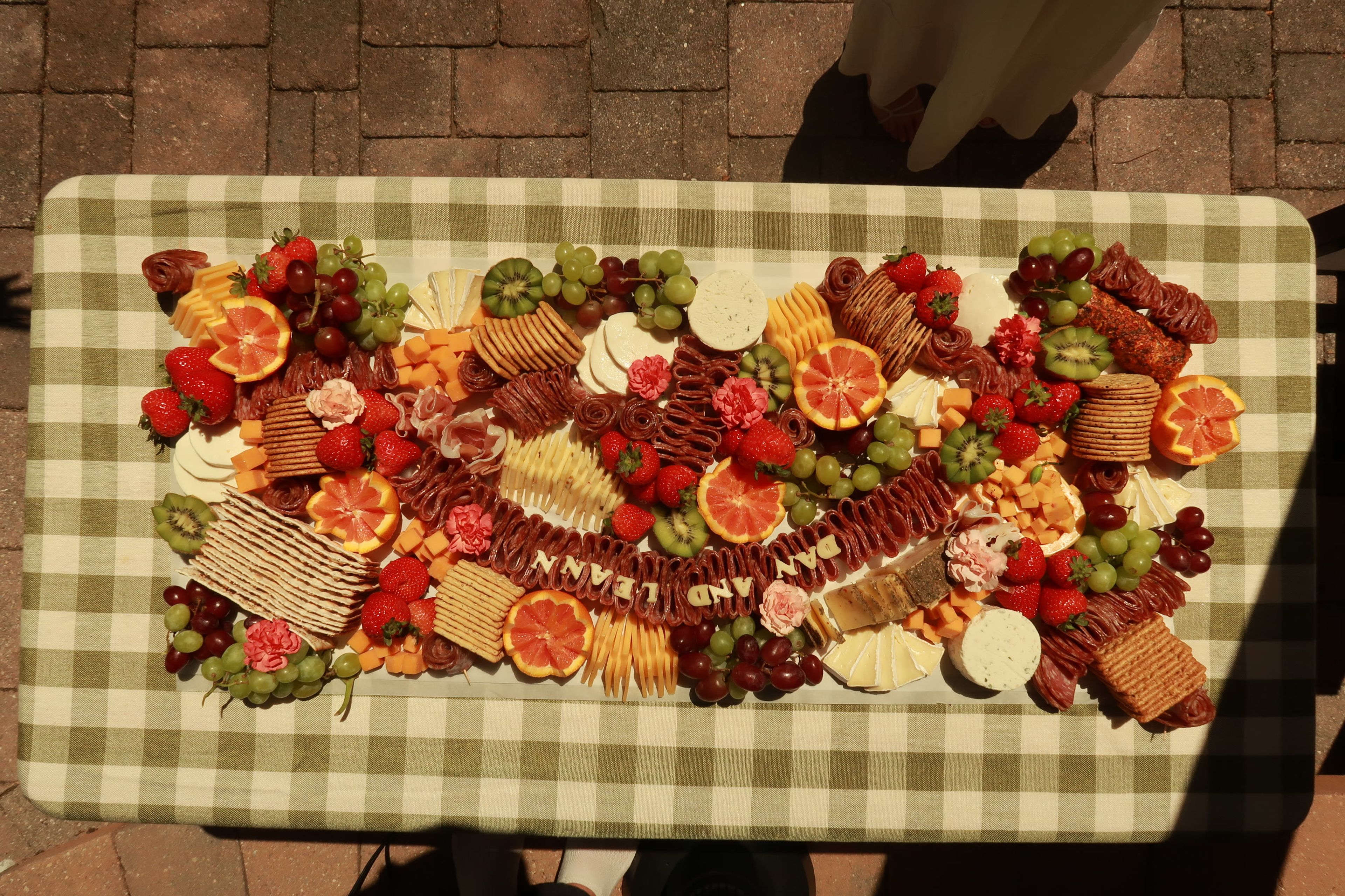 A grazing board set out on a brick patio