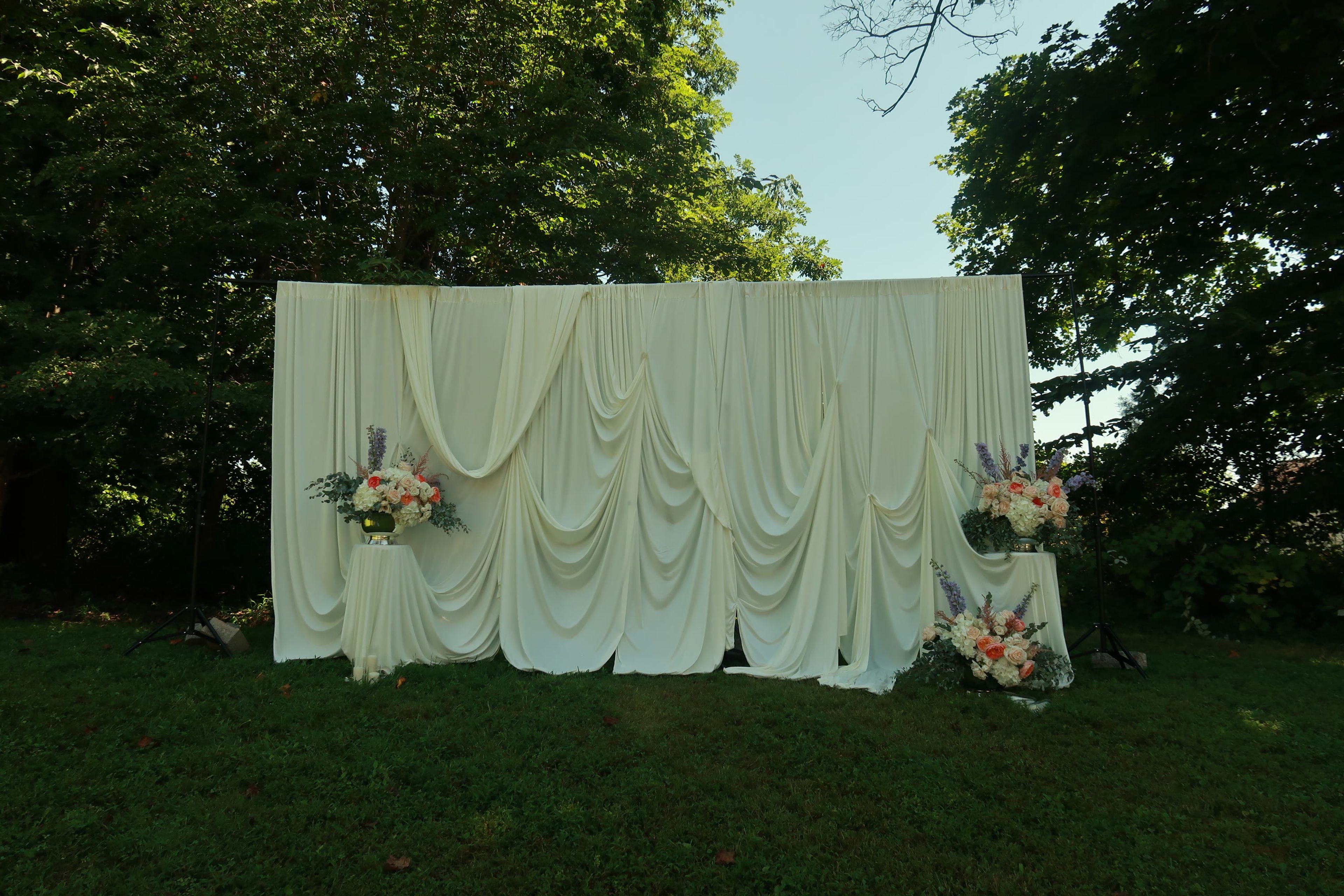 A draped table with floral arrangements at either end