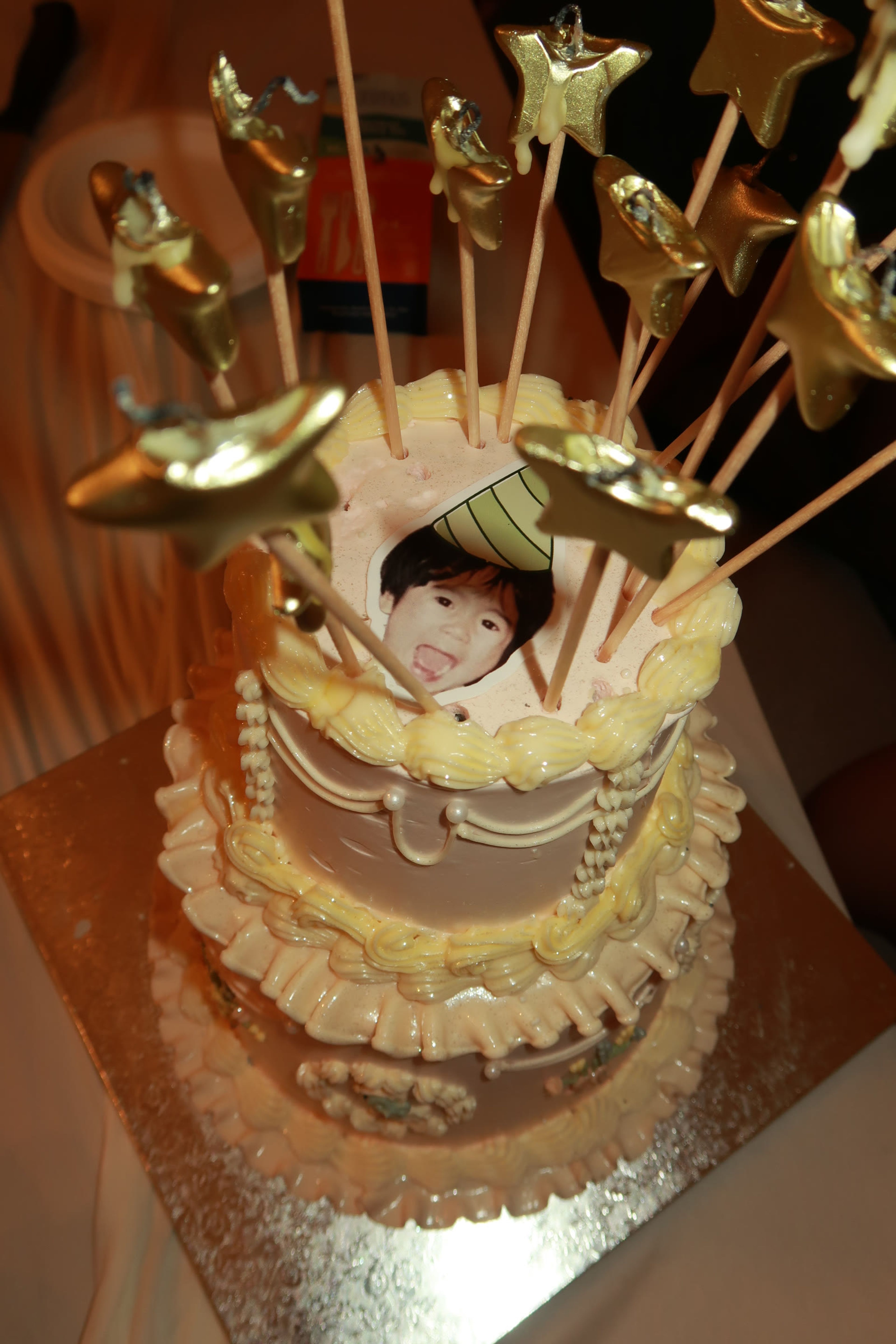 A cake trimmed with graduation cap picks and photo toppers