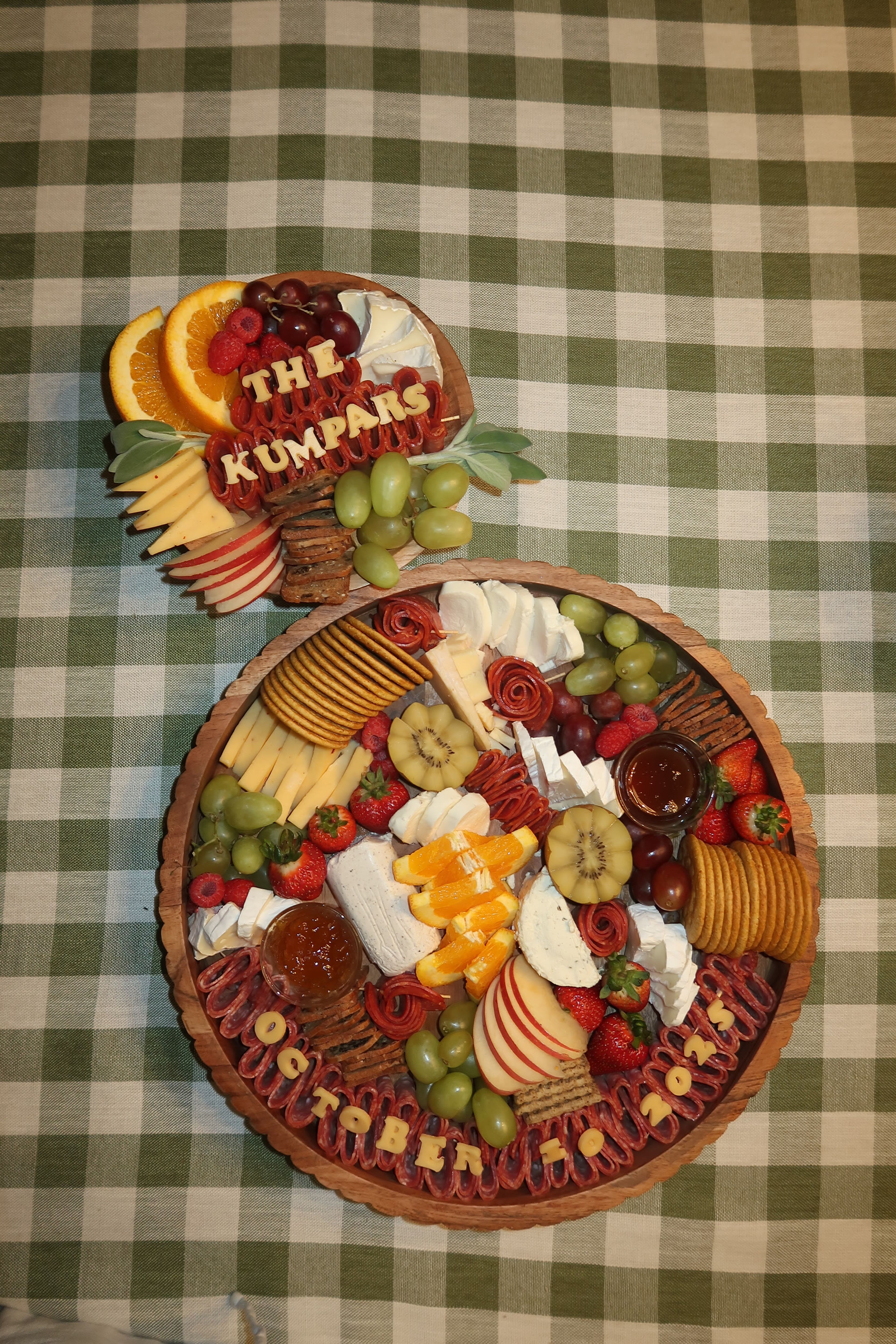 A round grazing board lettered for the Kumpars on green gingham