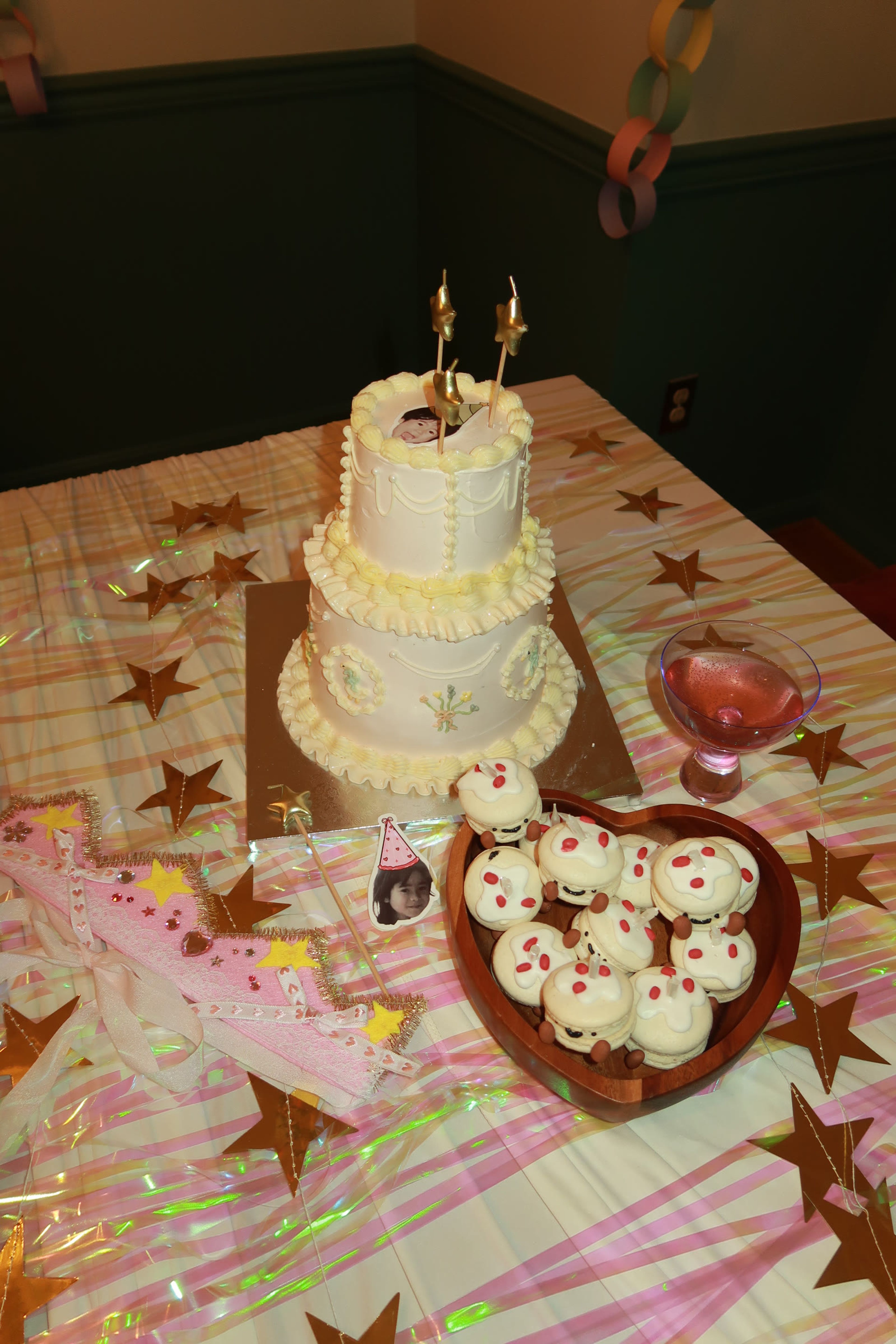 A tiered cake beside a heart-shaped board of cupcakes