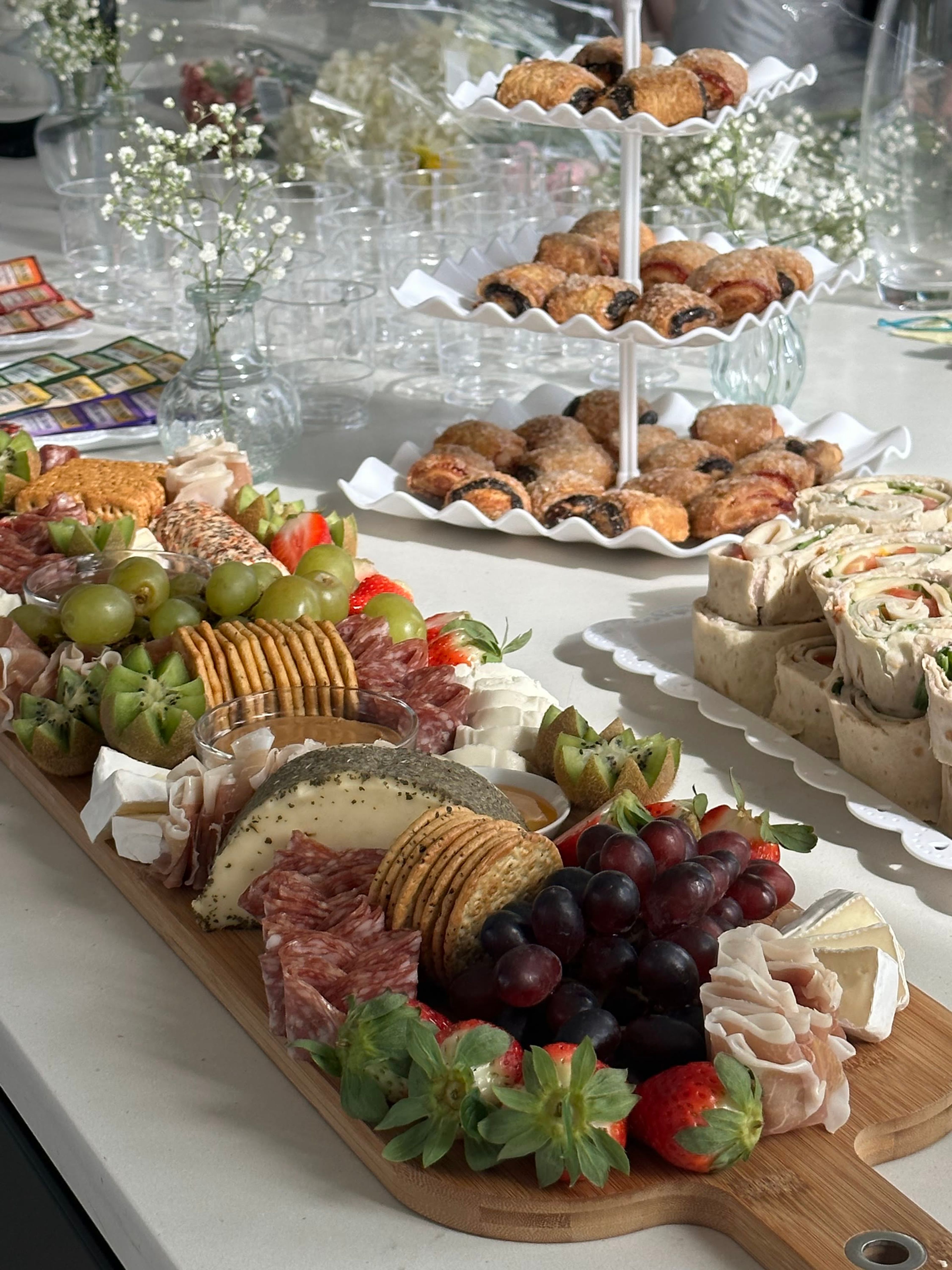 A dessert table with pastries and tiered stands