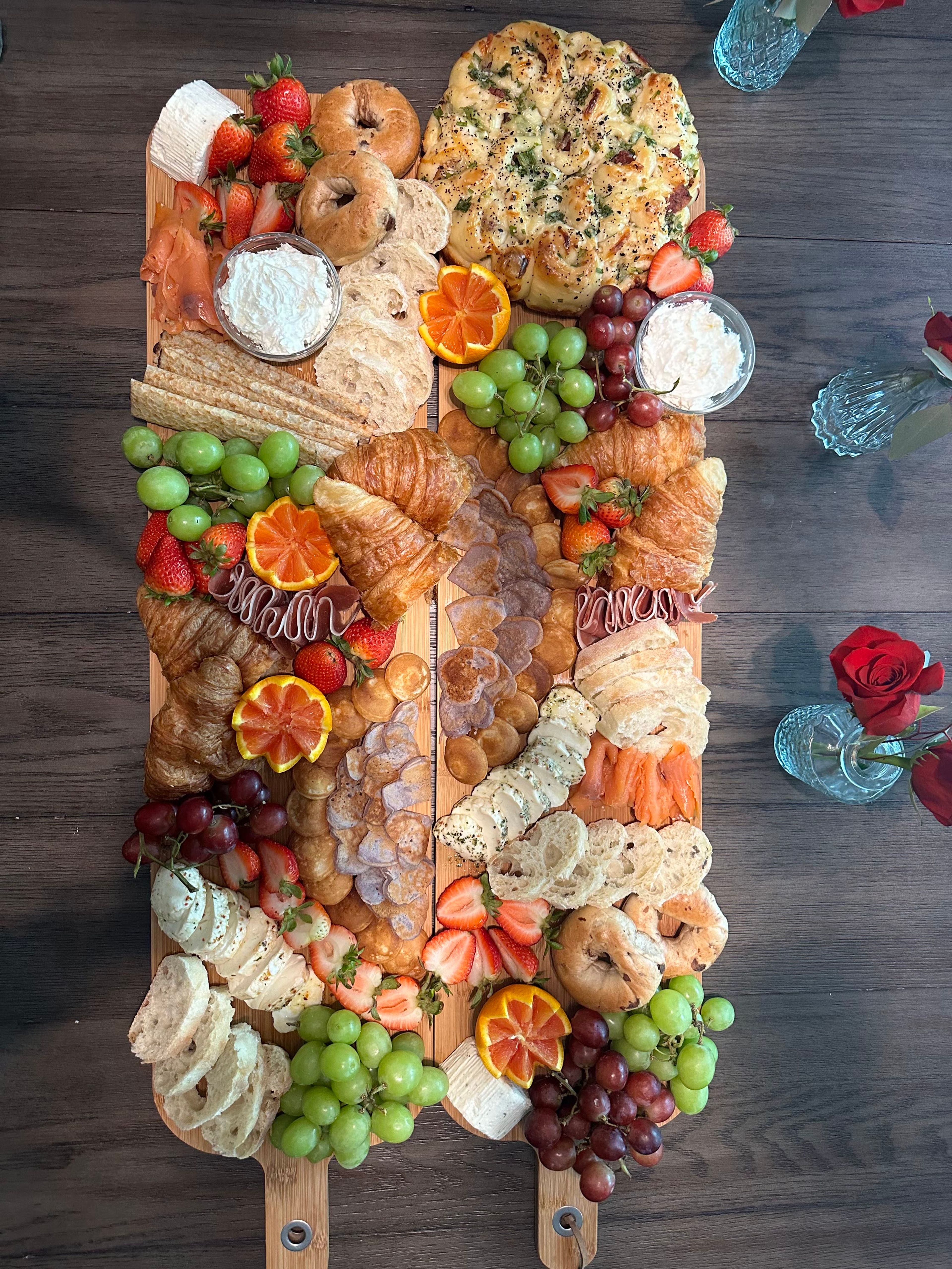 A vertical board of citrus, cheese and grapes on wood