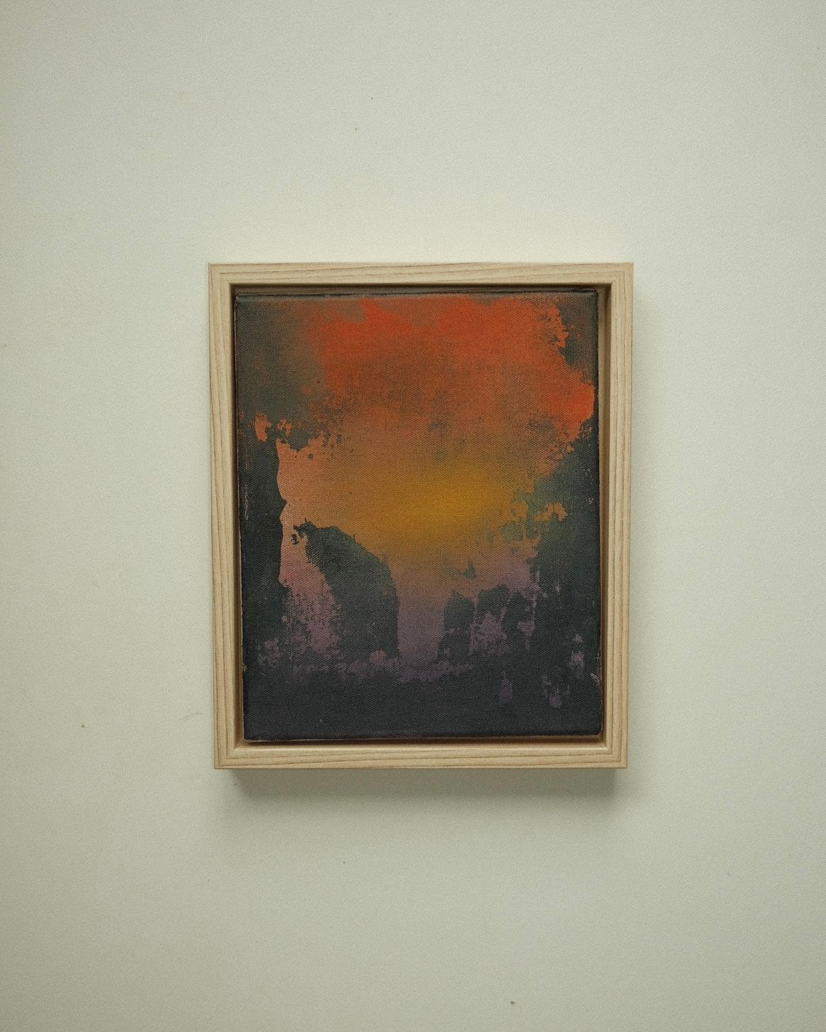 Dark, almost black abstract with a burst of orange and yellow light at the top, and dark shapes rising from below like silhouetted cliffs.