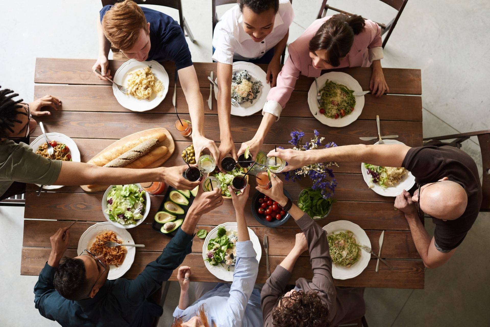Group of friends celebrating together around a dining table